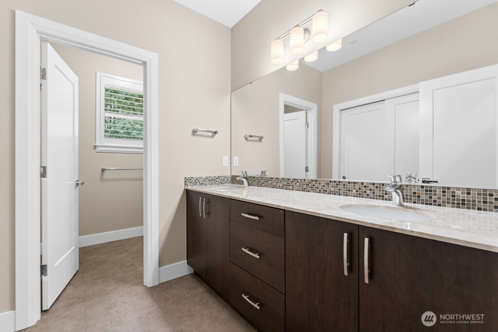 6578 Serenity Loop Gig Harbor, WA 98335 - Photo 29 of 38 a bathroom with a double vanity sink and a mirror