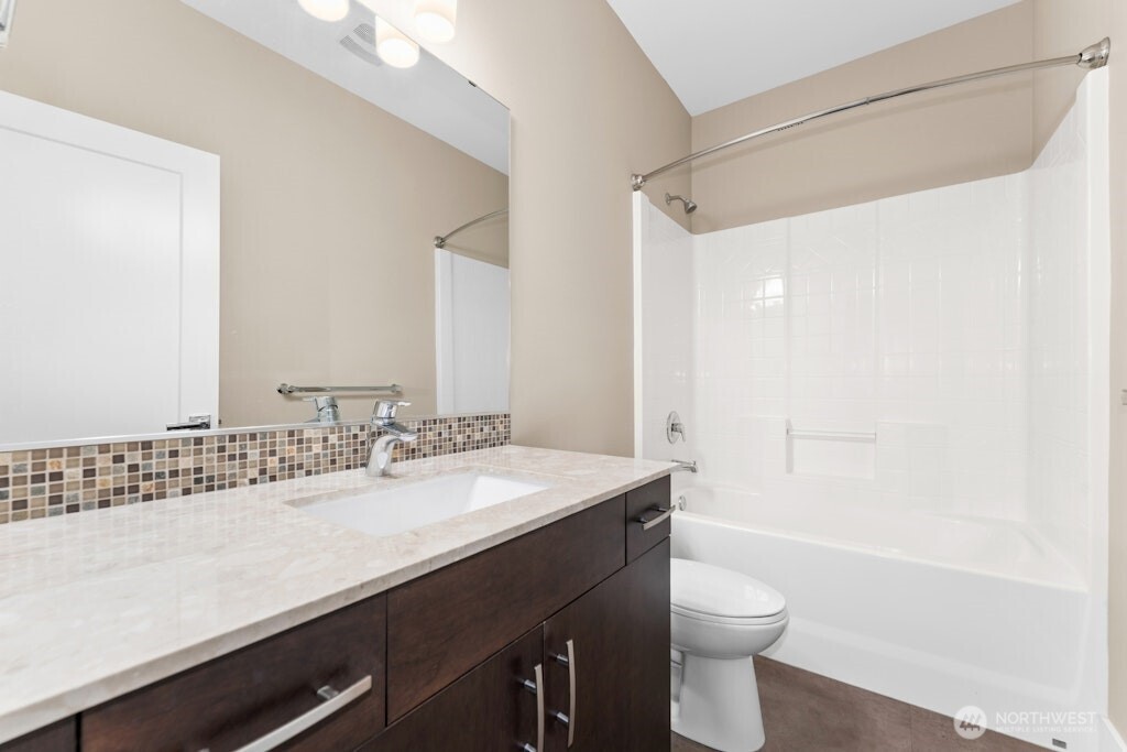 6578 Serenity Loop Gig Harbor, WA 98335 - Photo 32 of 38 a bathroom with a sink a toilet and shower