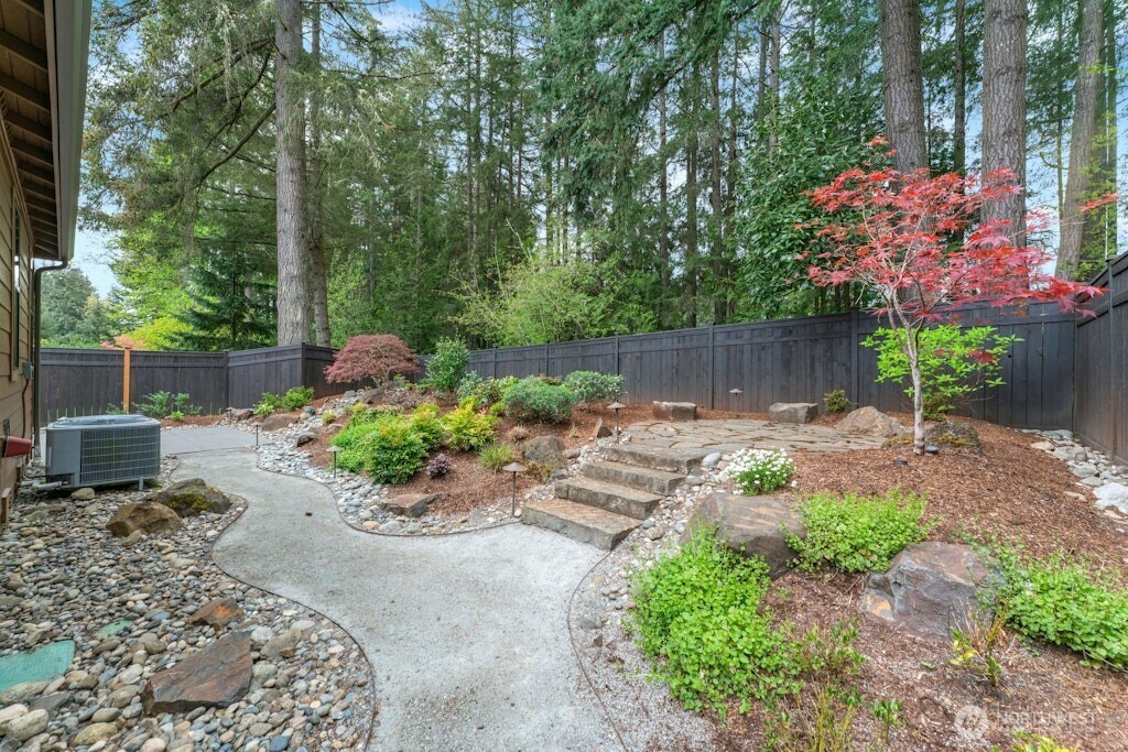 6578 Serenity Loop Gig Harbor, WA 98335 - Photo 34 of 38 a garden with flowers and trees