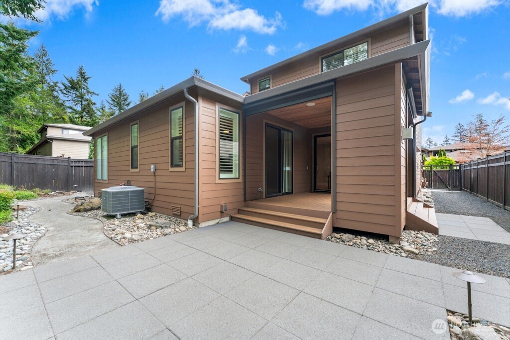 6578 Serenity Loop Gig Harbor, WA 98335 - Photo 35 of 38 a backyard of a house with yard and outdoor seating