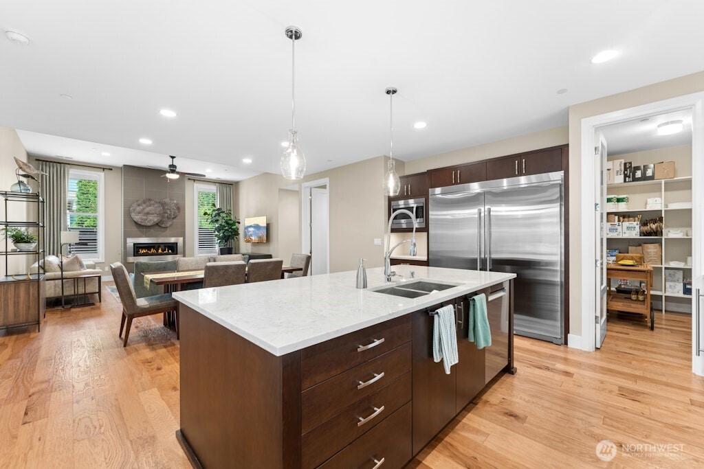 6578 Serenity Loop Gig Harbor, WA 98335 - Photo 9 of 38 a large kitchen with kitchen island a sink table and chairs
