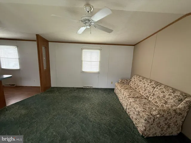 a bed sitting in a room next to a window