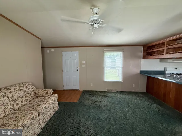 a bedroom with a bed and a ceiling fan