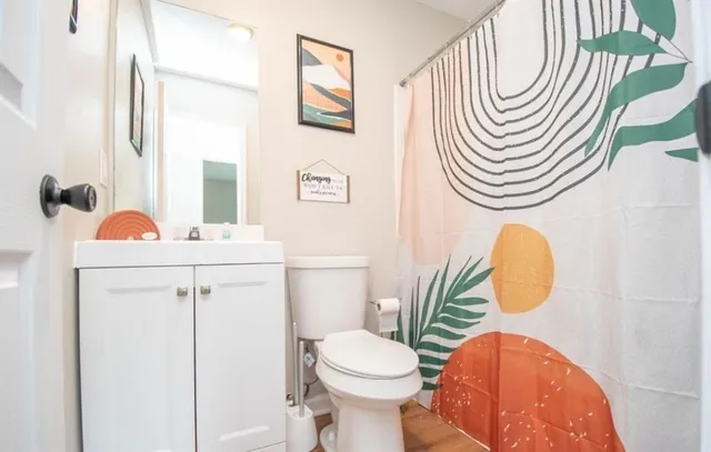 a bathroom with a sink a toilet and a mirror