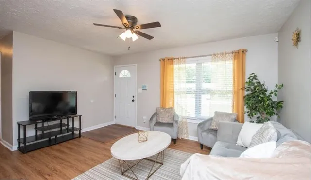 a living room with furniture and a flat screen tv