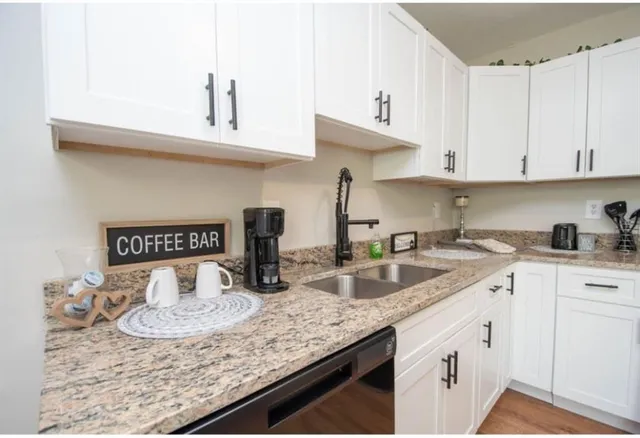 a kitchen with sink and cabinets