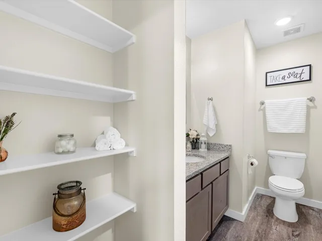 a bathroom with a toilet a sink and a mirror