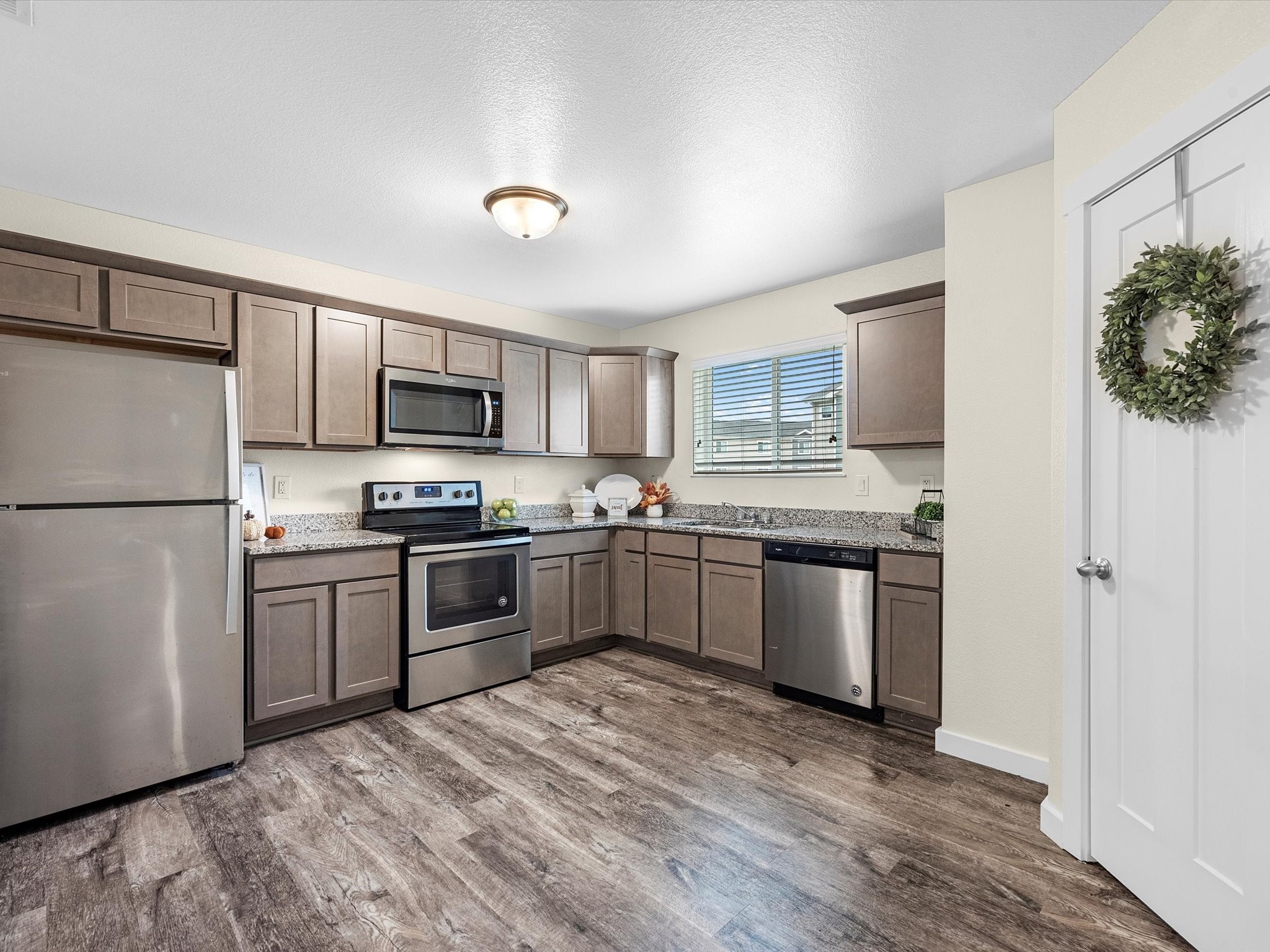 21155 Gosling Road, Unit 20A Spring, TX 77388 - Photo 2 of 37 a kitchen with granite countertop stainless steel appliances and wooden cabinets