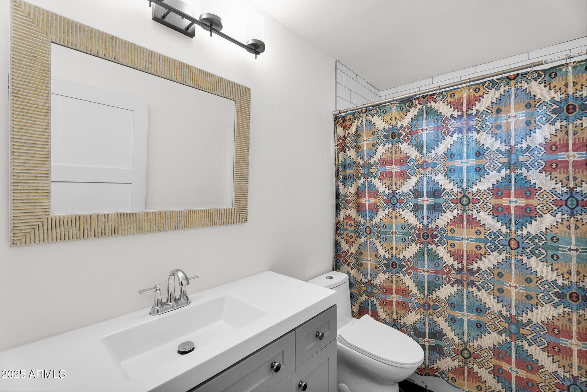 2434 North 37th Way Phoenix, AZ 85008 - Photo 13 of 17 a bathroom with a sink and a mirror
