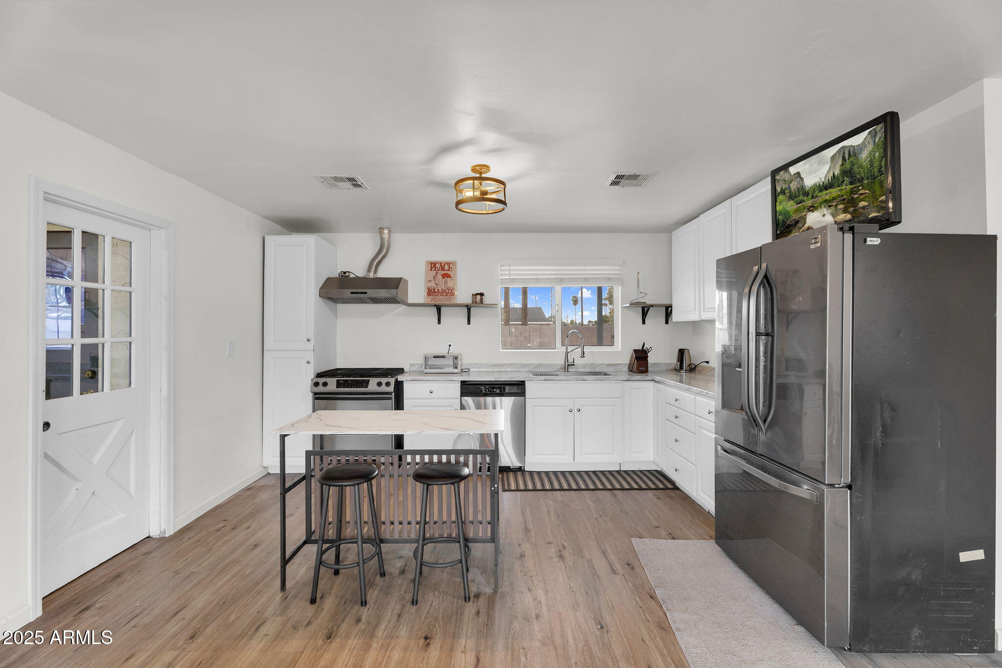 2434 North 37th Way Phoenix, AZ 85008 - Photo 5 of 17 a kitchen with stainless steel appliances a refrigerator and a stove top oven