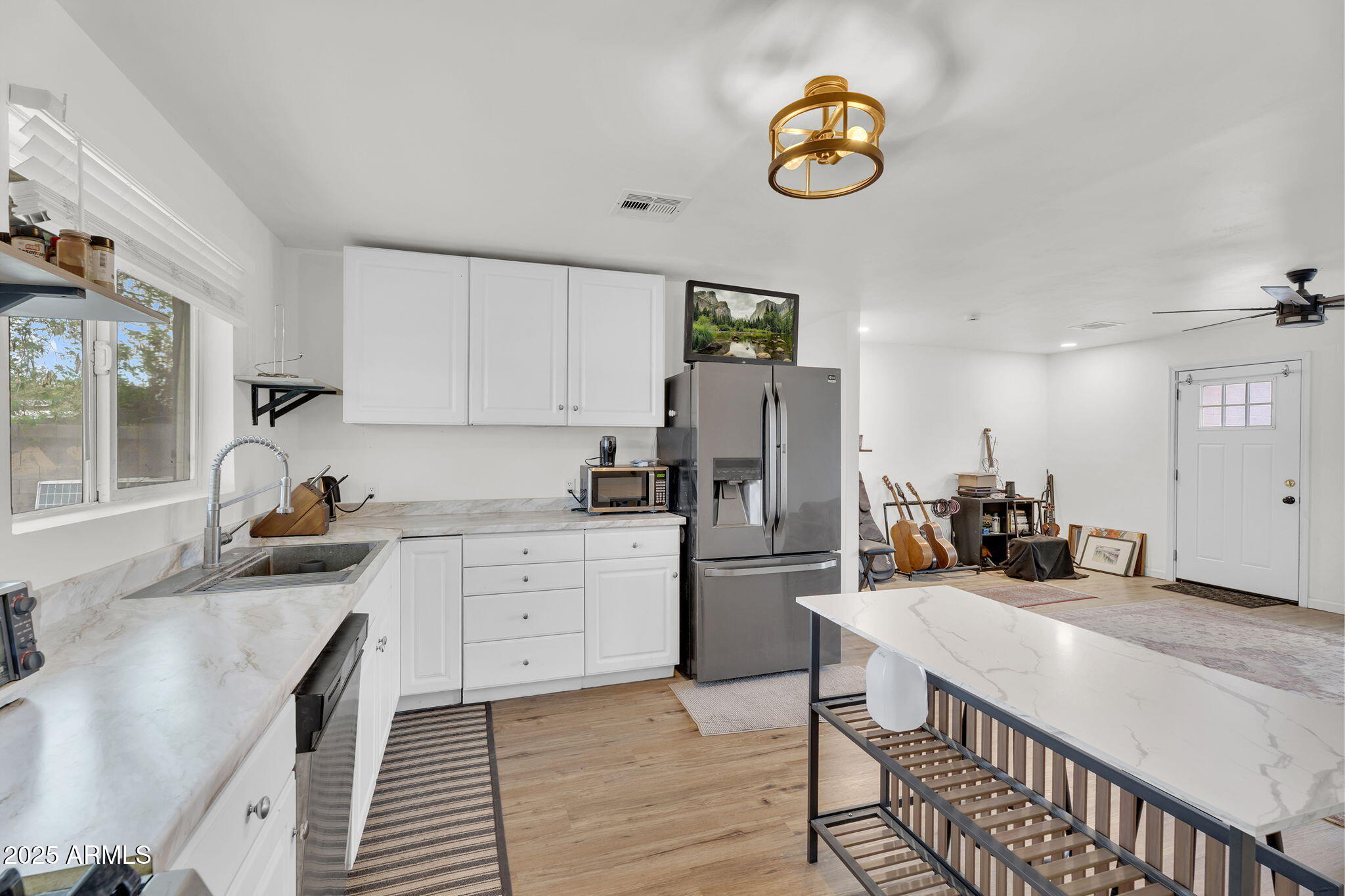 2434 North 37th Way Phoenix, AZ 85008 - Photo 8 of 17 a kitchen with stainless steel appliances granite countertop a sink a stove a refrigerator cabinets and chairs
