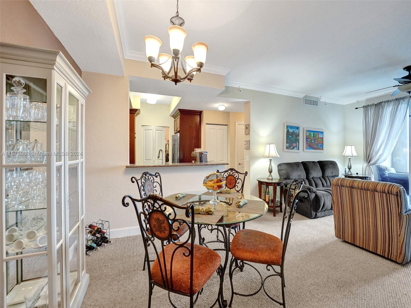 1660 Renaissance Commons Boulevard, Unit 2508 Boynton Beach, FL 33426 - Photo 11 of 28 a view of a dining room and livingroom with furniture wooden floor a chandelier