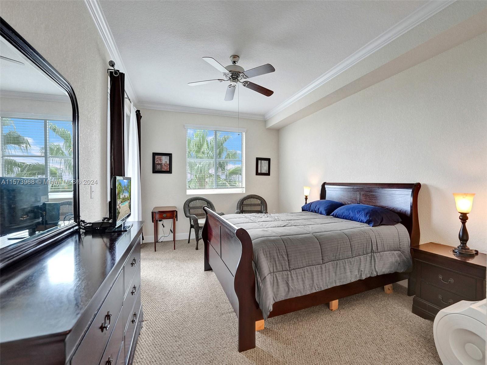 1660 Renaissance Commons Boulevard, Unit 2508 Boynton Beach, FL 33426 - Photo 12 of 28 a bed room with a bed and a chandelier
