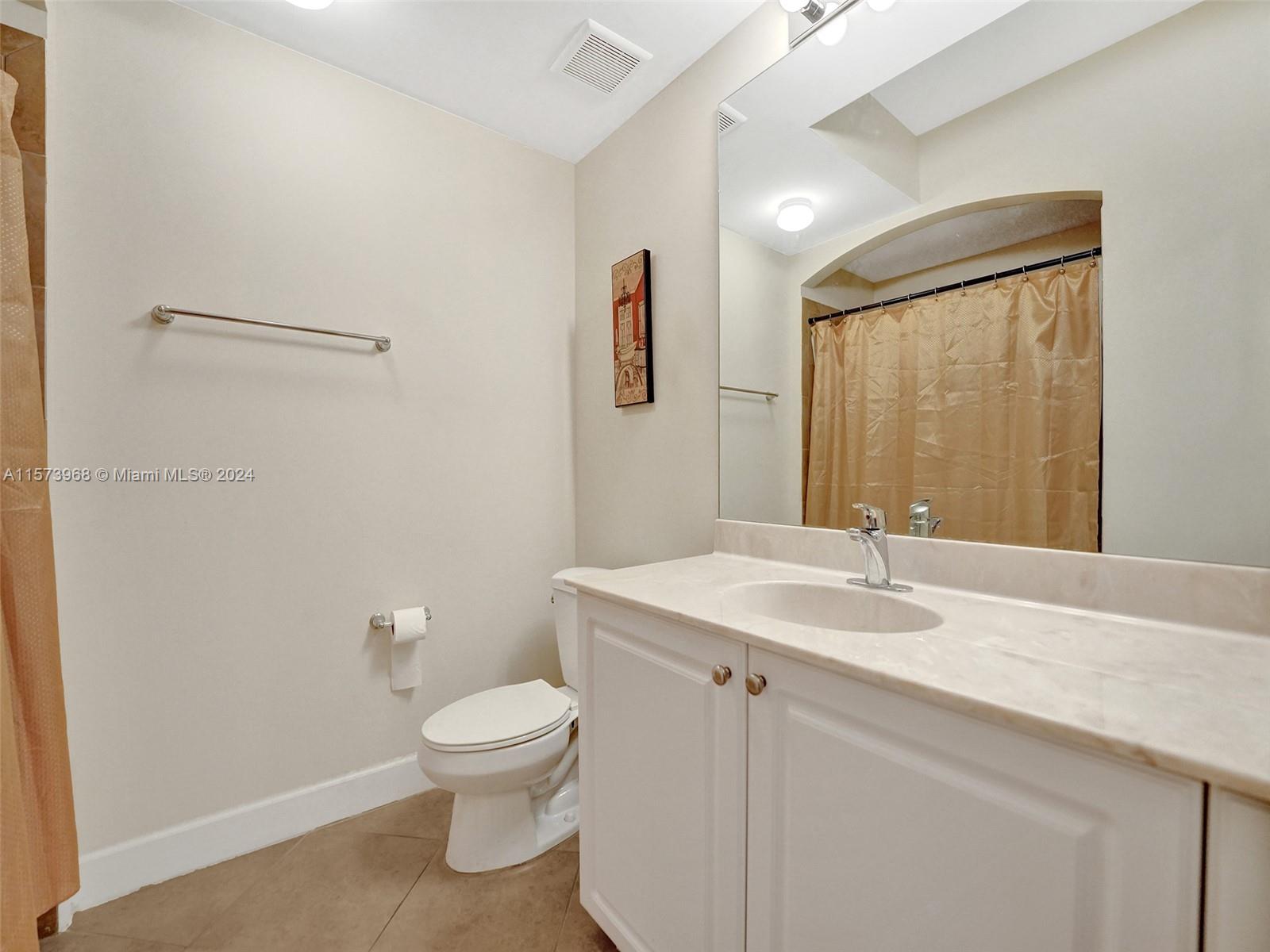 1660 Renaissance Commons Boulevard, Unit 2508 Boynton Beach, FL 33426 - Photo 18 of 28 a bathroom with a granite countertop sink toilet a large mirror and shower