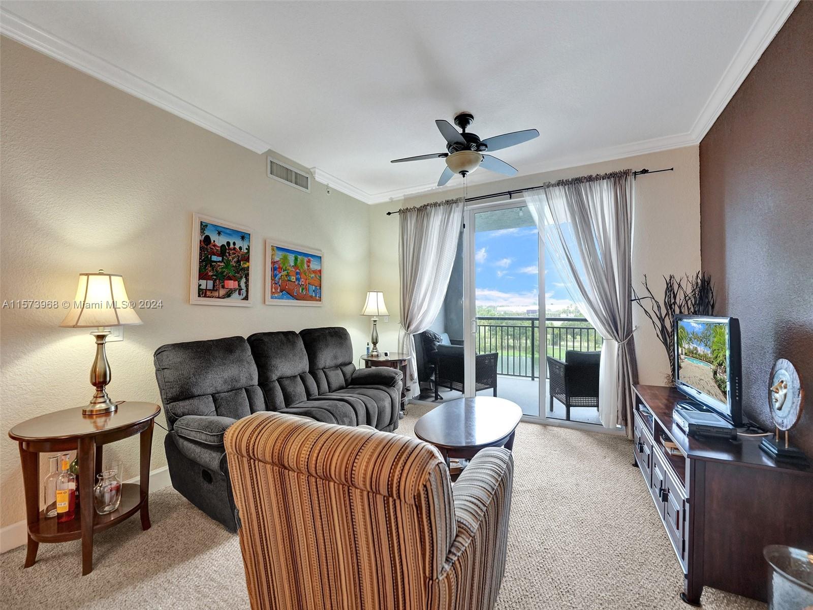 1660 Renaissance Commons Boulevard, Unit 2508 Boynton Beach, FL 33426 - Photo 7 of 28 a living room with furniture a flat screen tv and a large window