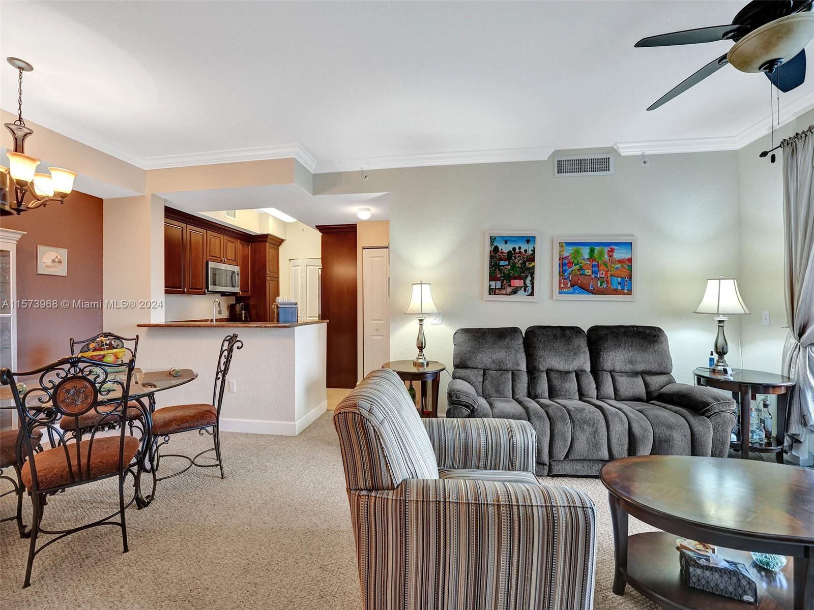 1660 Renaissance Commons Boulevard, Unit 2508 Boynton Beach, FL 33426 - Photo 8 of 28 a living room with furniture and a wooden floor