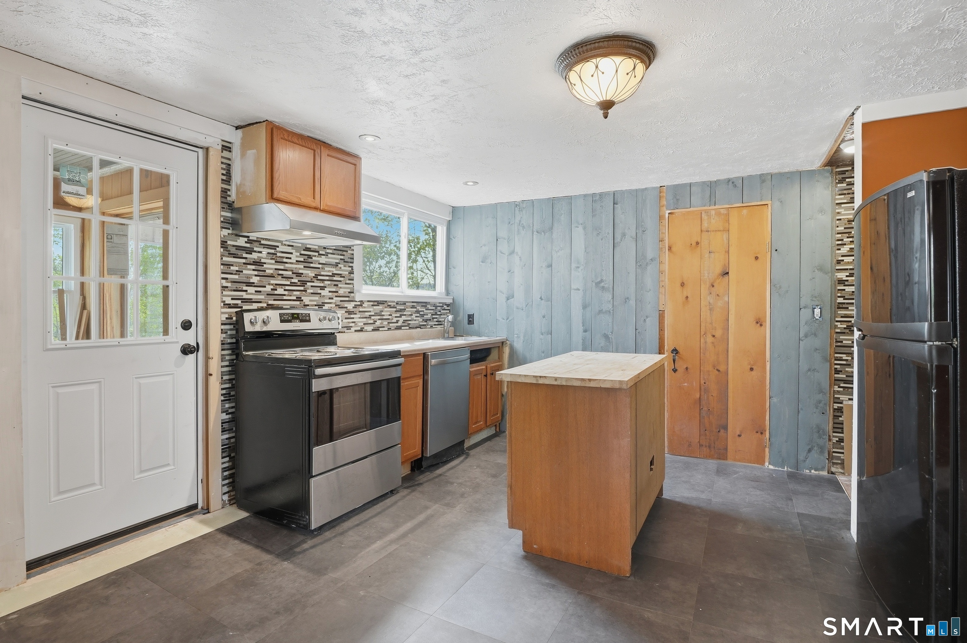 46 Pleasant Street Torrington, CT 06790 - Photo 25 of 40 a kitchen with a stove and a refrigerator