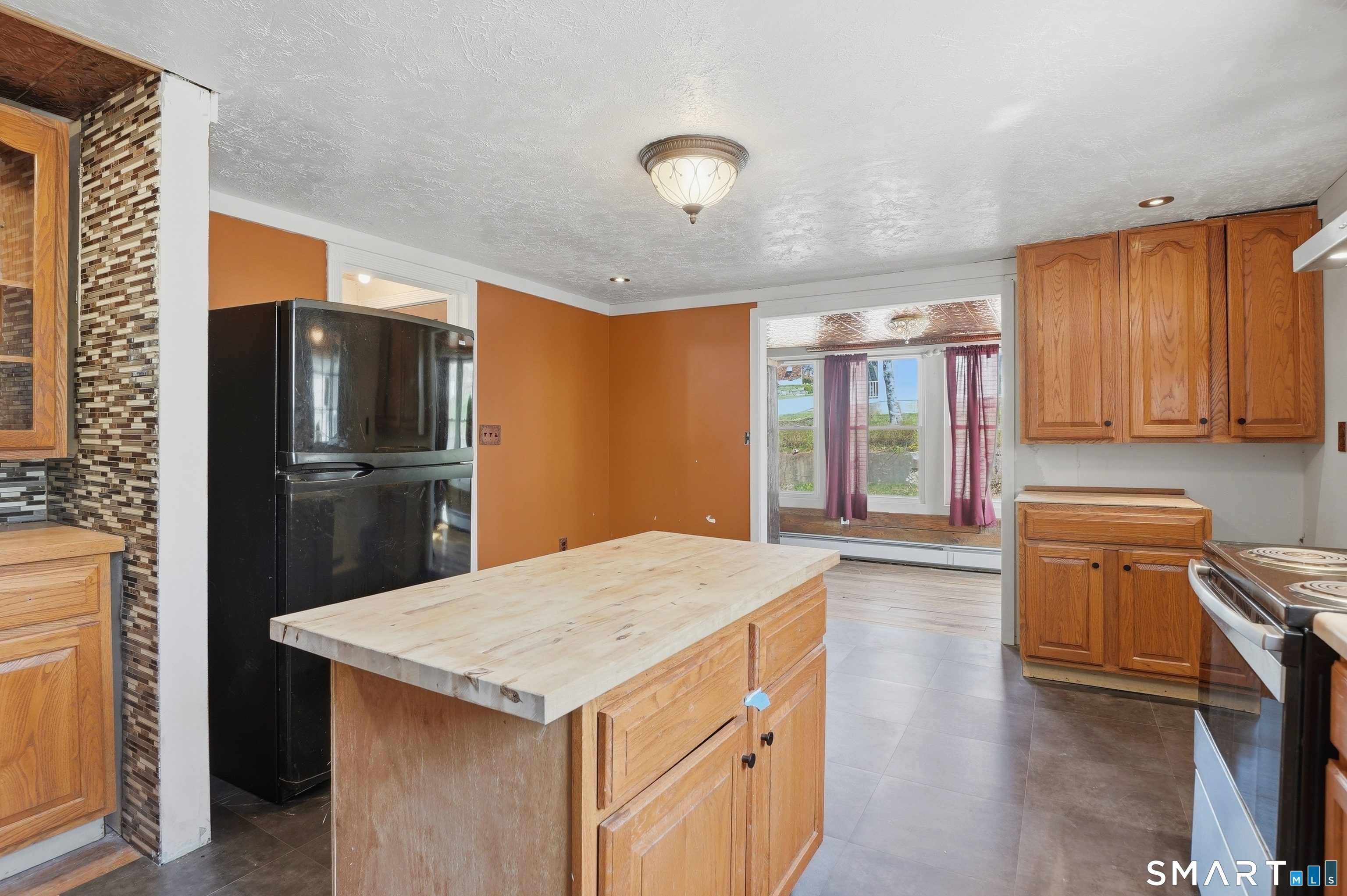 46 Pleasant Street Torrington, CT 06790 - Photo 27 of 40 a kitchen with stainless steel appliances granite countertop a refrigerator a stove and a sink with wooden floor