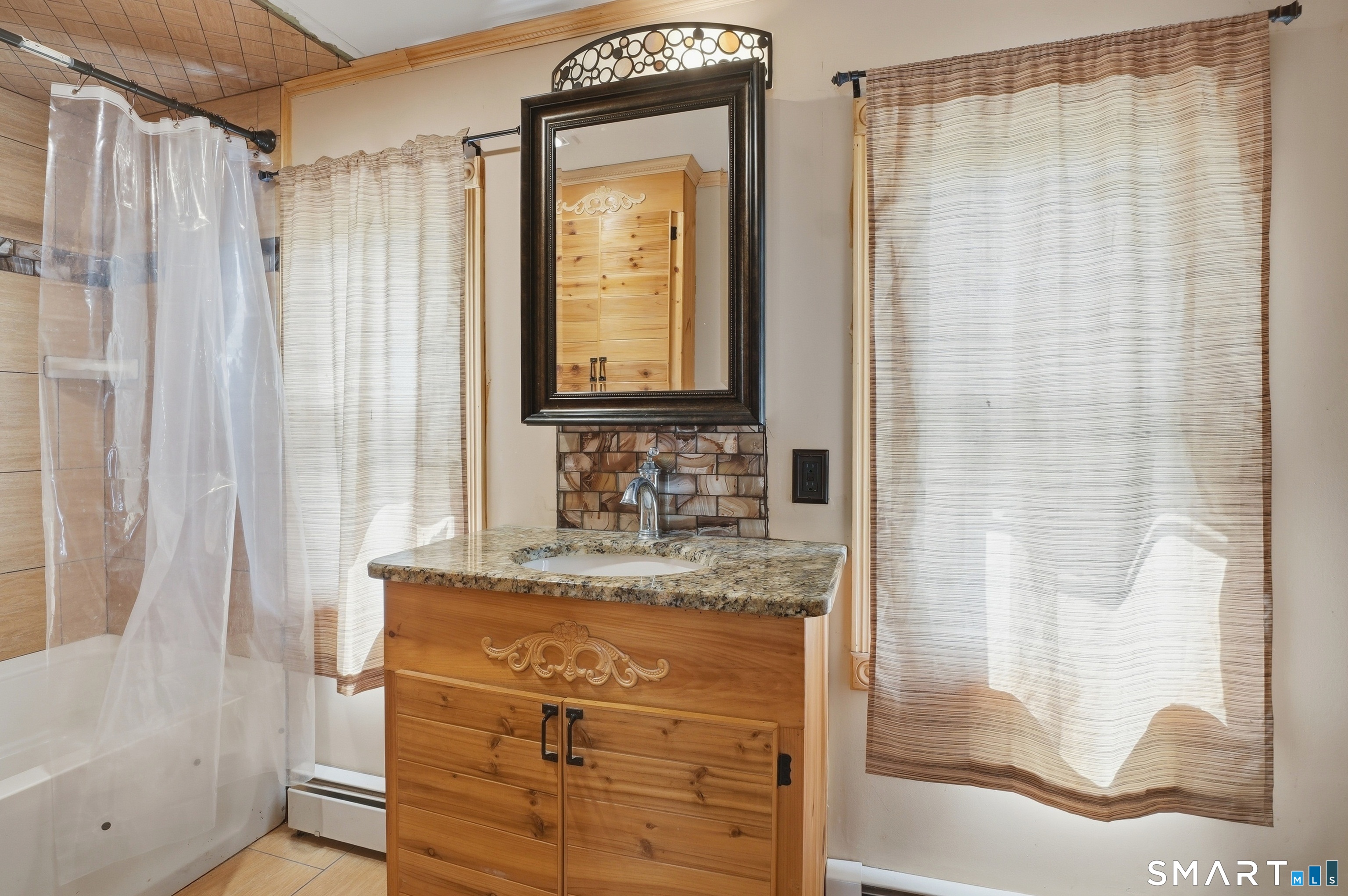 46 Pleasant Street Torrington, CT 06790 - Photo 29 of 40 a bathroom with a granite countertop sink and a mirror
