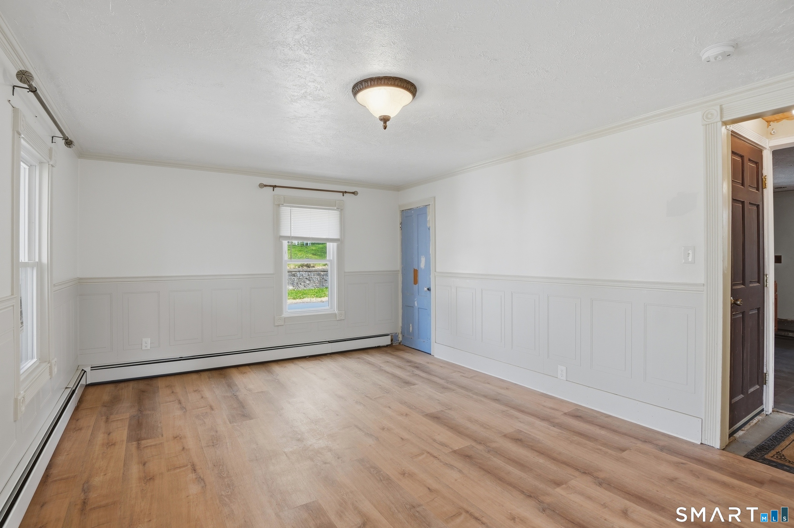 46 Pleasant Street Torrington, CT 06790 - Photo 32 of 40 an empty room with wooden floor and windows