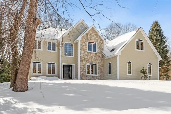 a view of a white house with large windows