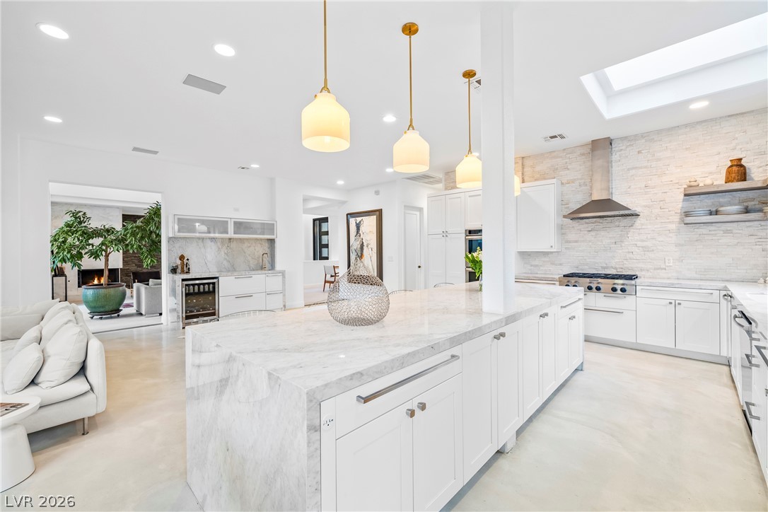 2000 Grouse Street Las Vegas, NV 89134 - Photo 27 of 89 Gleaming white cabinetry and marble countertops define this expansive culinary space.