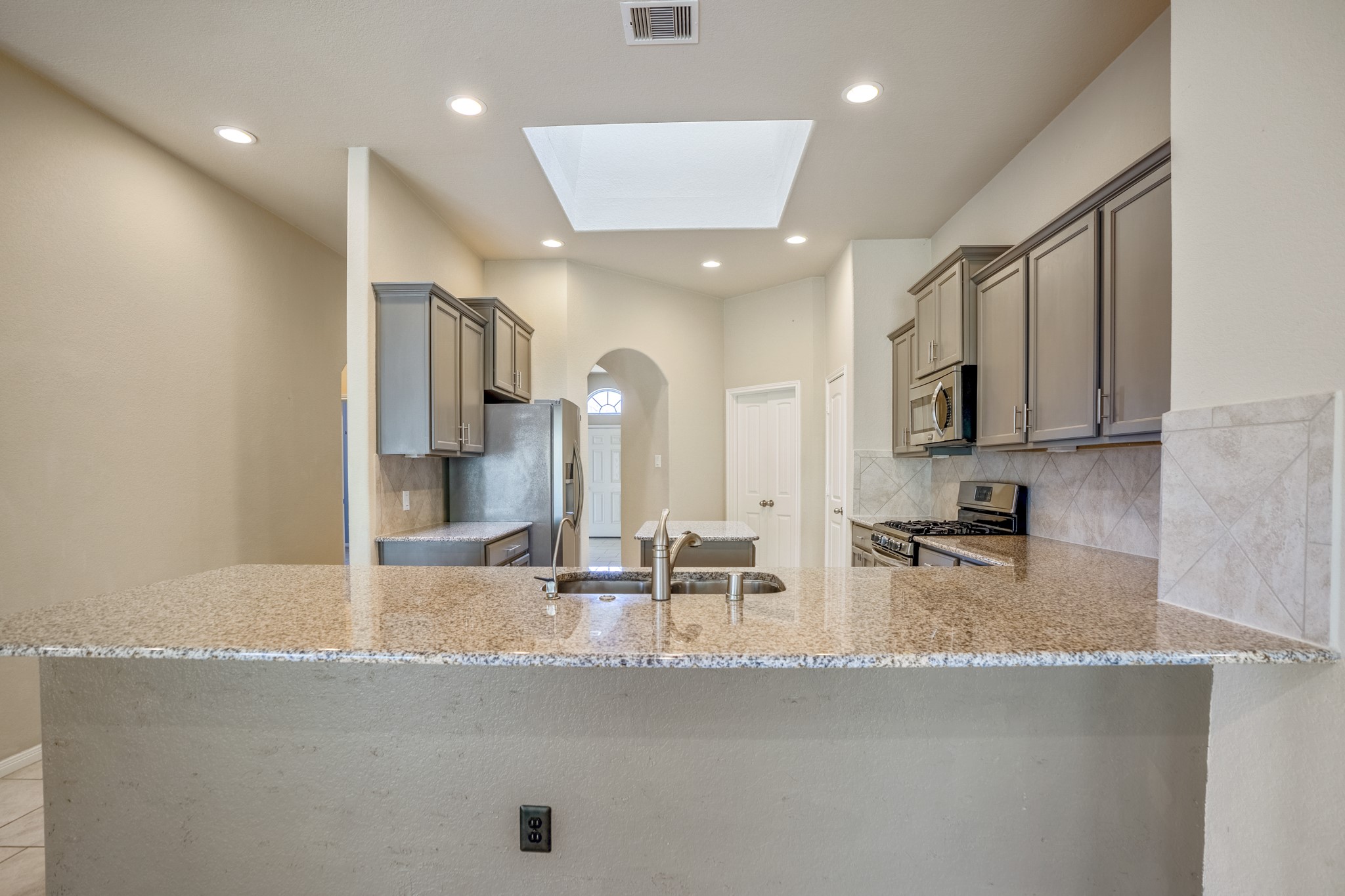 5319 Claymore Meadow Lane Spring, TX 77389 - Photo 15 of 34 a kitchen with stainless steel appliances granite countertop a sink a stove and a refrigerator