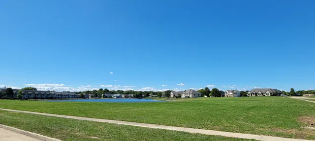 a view of a grassy field with clear sky