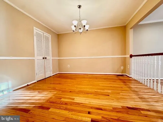 a kitchen with a sink a refrigerator and wooden floor