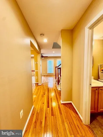a view of an empty room with a fireplace and a window