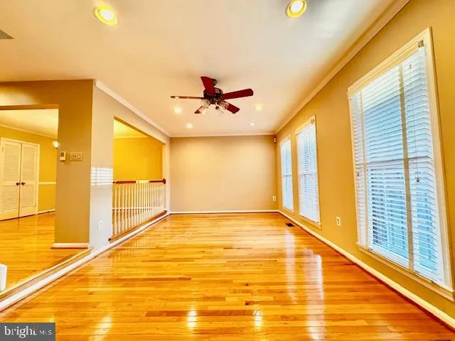 a view of a room with wooden floor staircase and a kitchen