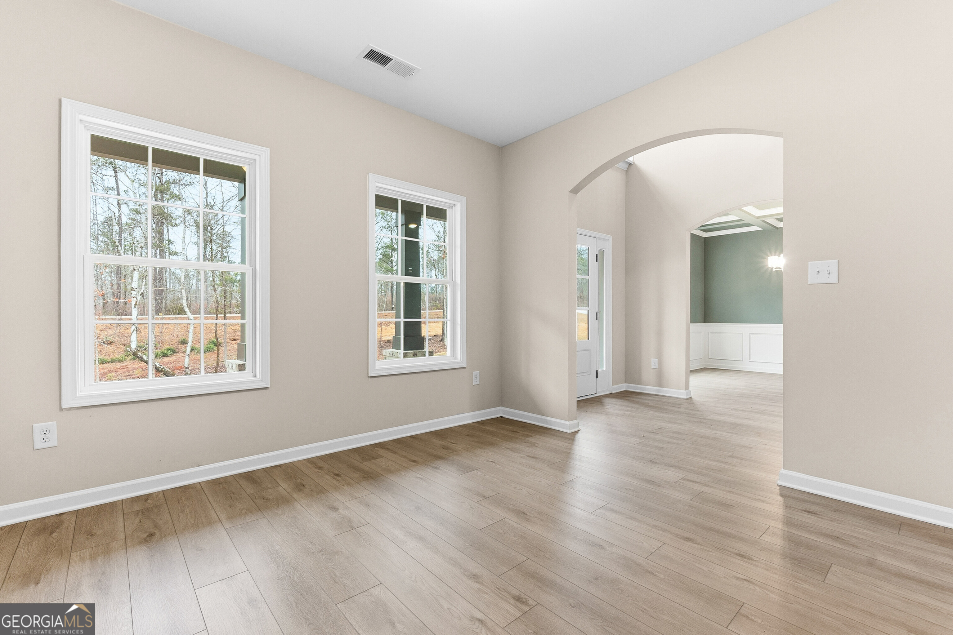 1649 Stokes Store Road, Unit 52 Forsyth, GA 31029 - Photo 15 of 73 an empty room with wooden floor and windows