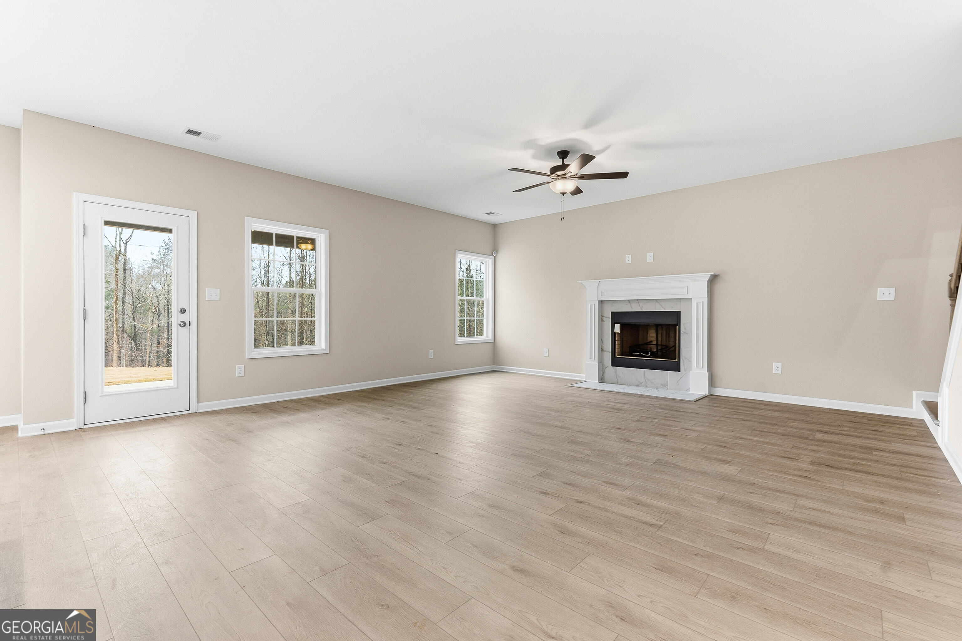 1649 Stokes Store Road, Unit 52 Forsyth, GA 31029 - Photo 16 of 73 a view of an empty room with window and wooden floor
