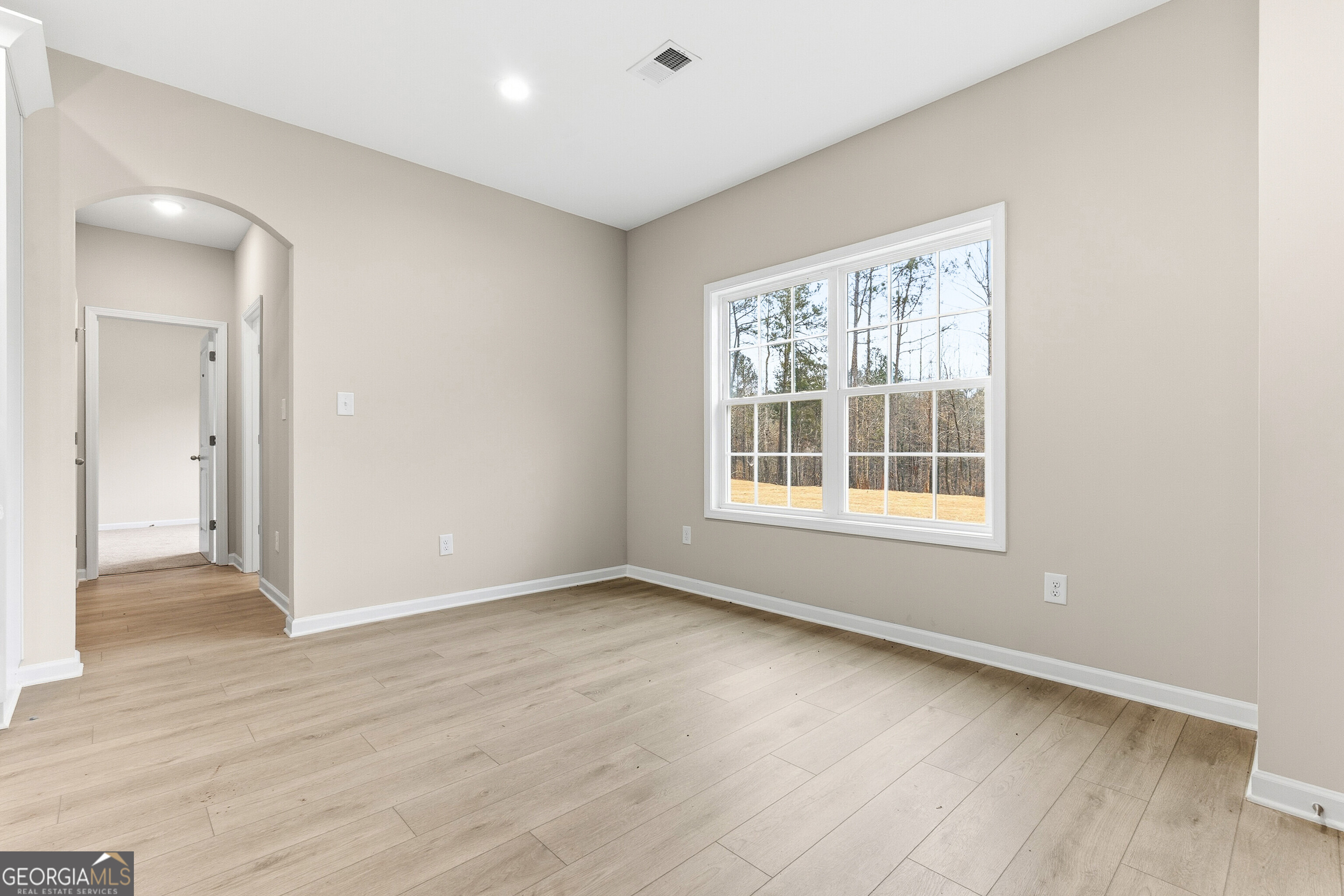 1649 Stokes Store Road, Unit 52 Forsyth, GA 31029 - Photo 21 of 73 a view of an empty room with wooden floor and a window