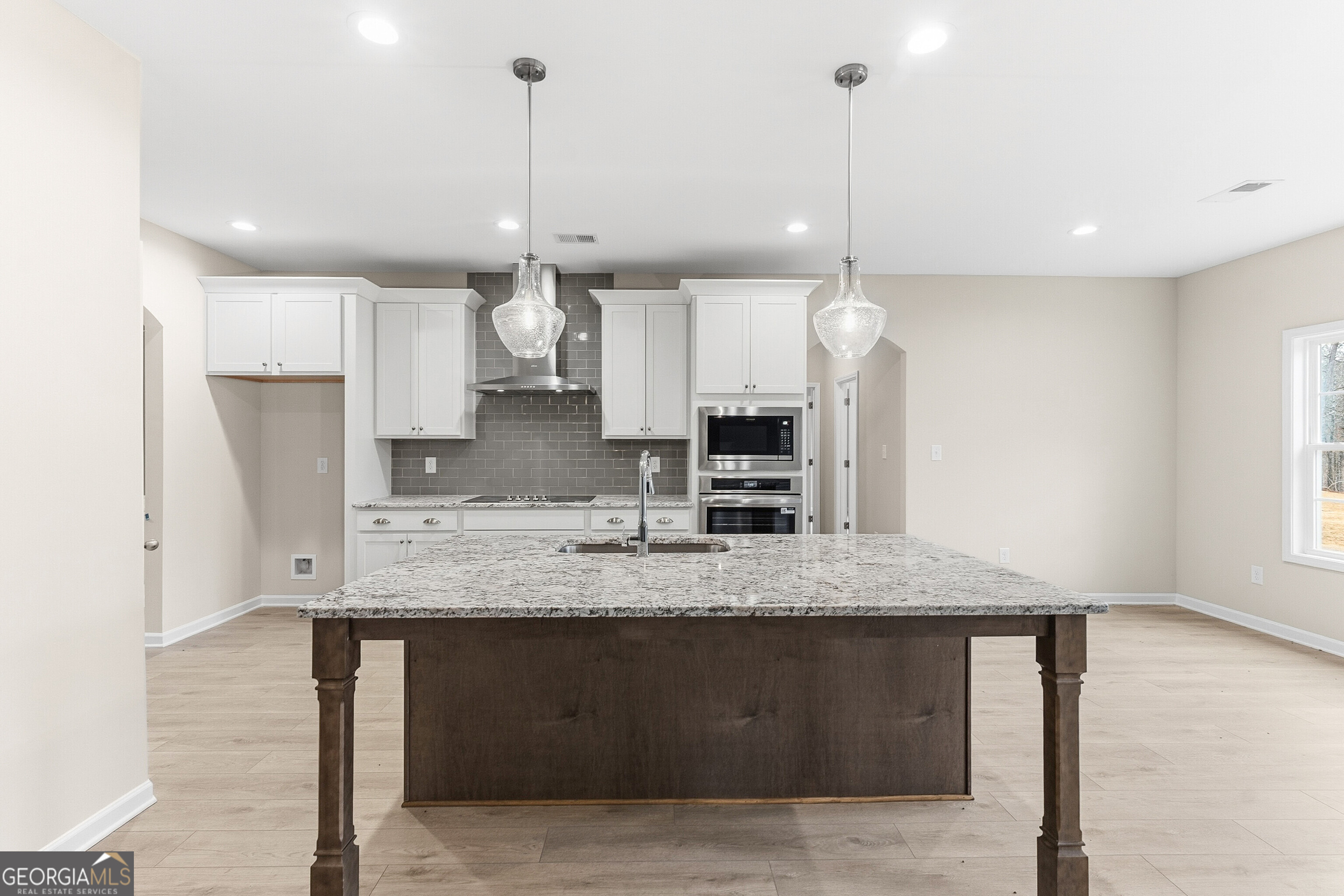 1649 Stokes Store Road, Unit 52 Forsyth, GA 31029 - Photo 24 of 73 a view of a kitchen with kitchen island a sink stainless steel appliances and a window