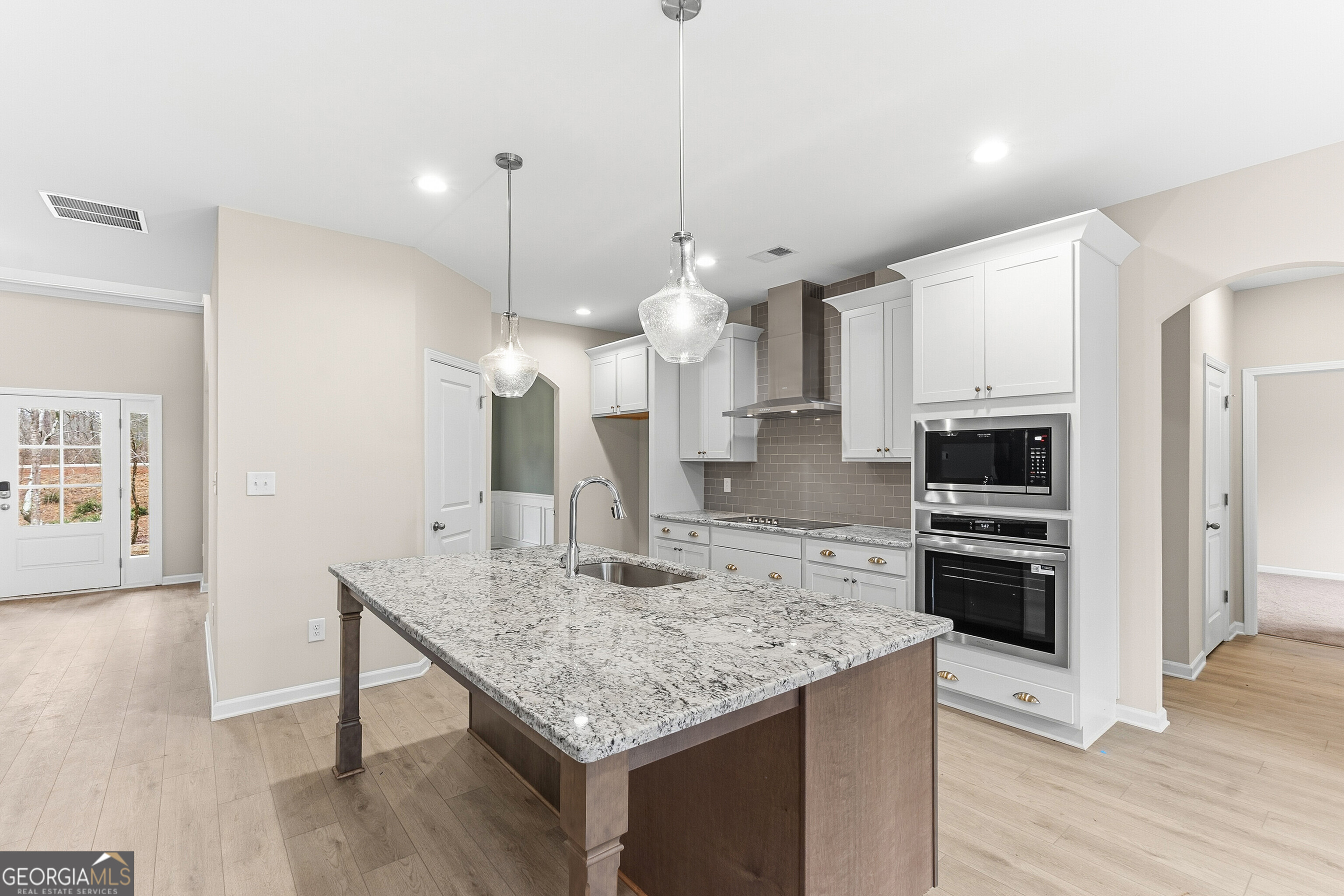 1649 Stokes Store Road, Unit 52 Forsyth, GA 31029 - Photo 27 of 73 a kitchen with kitchen island a counter space a sink appliances and cabinets