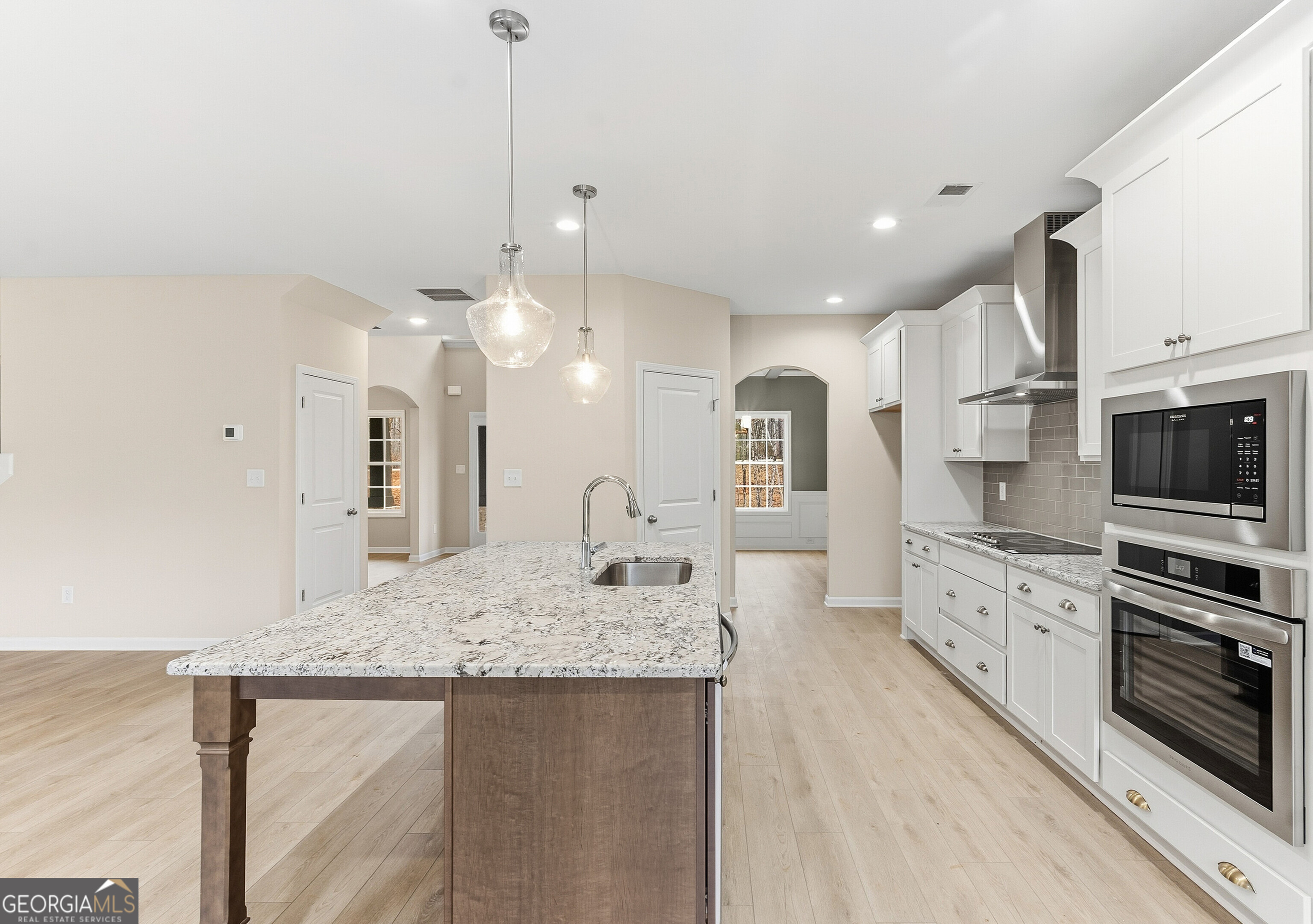 1649 Stokes Store Road, Unit 52 Forsyth, GA 31029 - Photo 28 of 73 a large kitchen with kitchen island a sink stainless steel appliances and cabinets