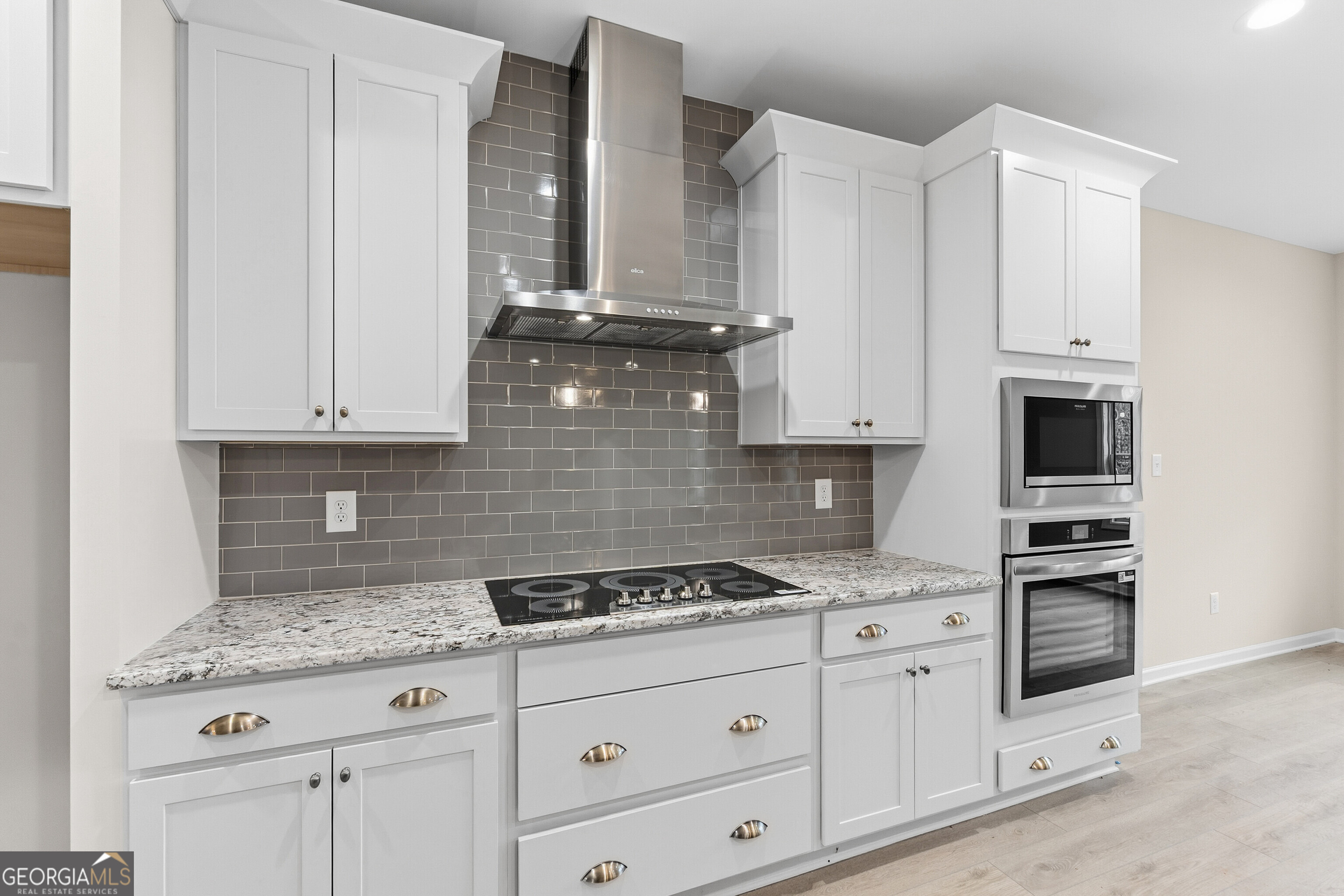 1649 Stokes Store Road, Unit 52 Forsyth, GA 31029 - Photo 30 of 73 a kitchen with granite countertop white cabinets and appliances