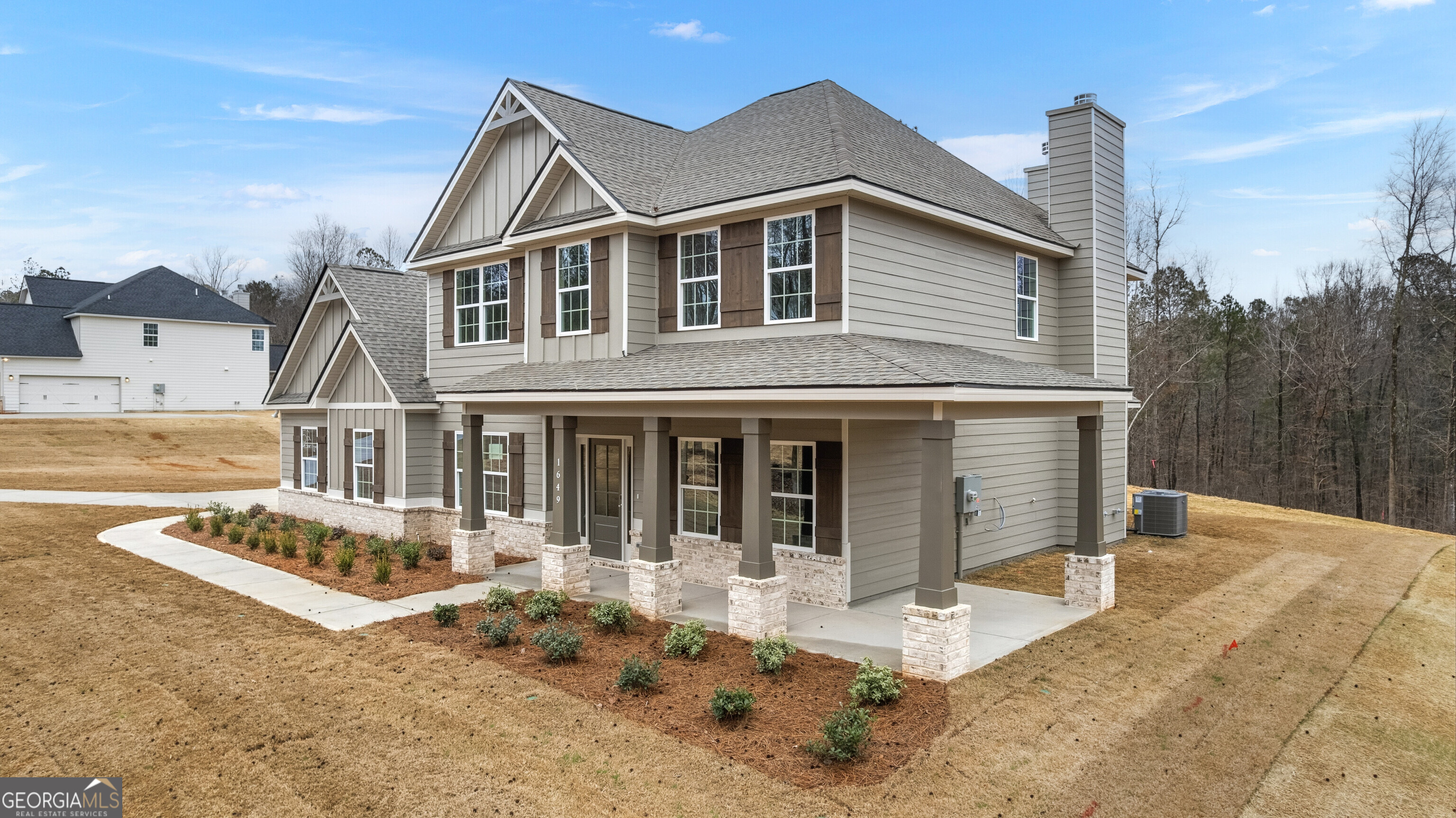 1649 Stokes Store Road, Unit 52 Forsyth, GA 31029 - Photo 3 of 73 a front view of a house with garden
