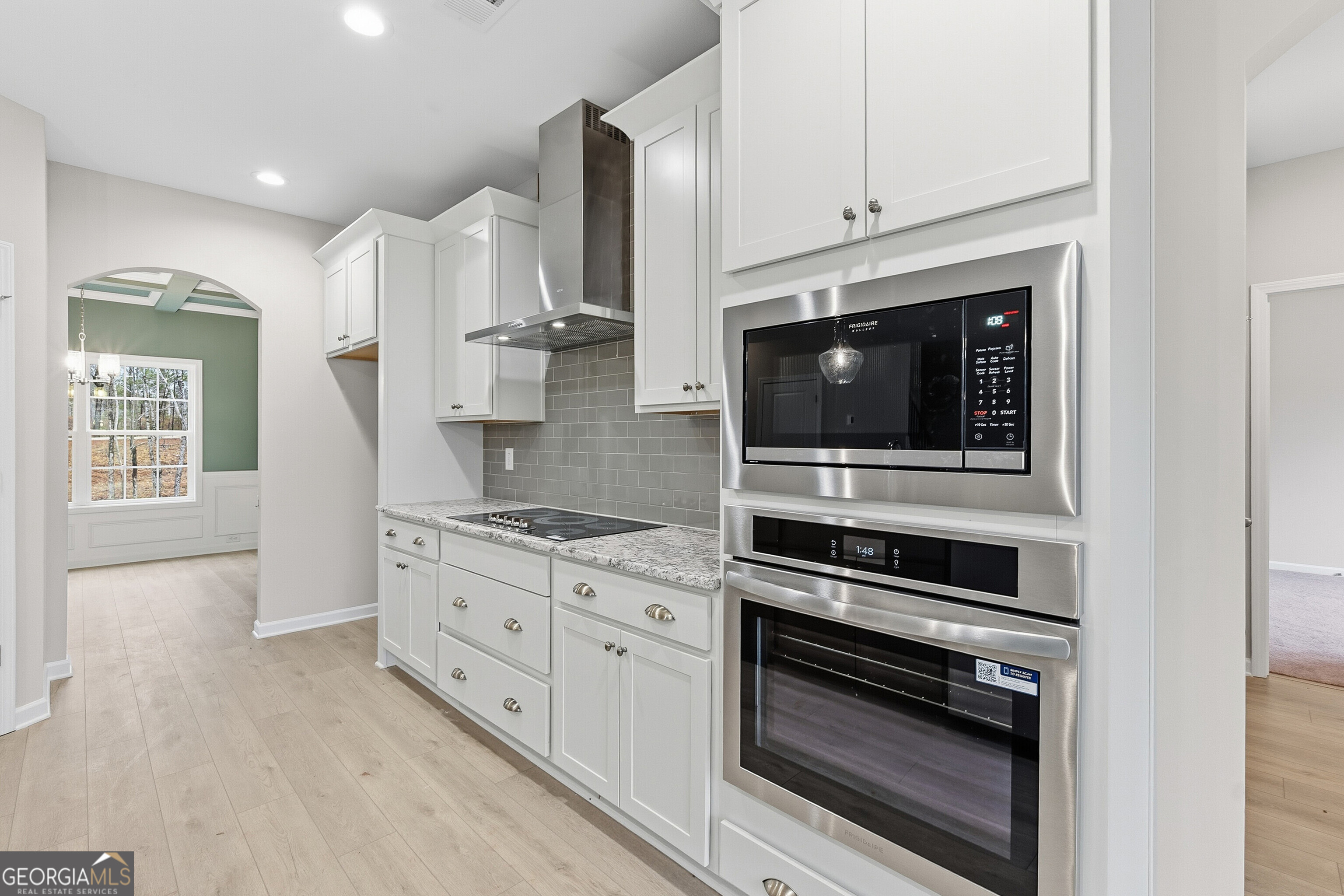 1649 Stokes Store Road, Unit 52 Forsyth, GA 31029 - Photo 31 of 73 a kitchen with stainless steel appliances a stove microwave and cabinets