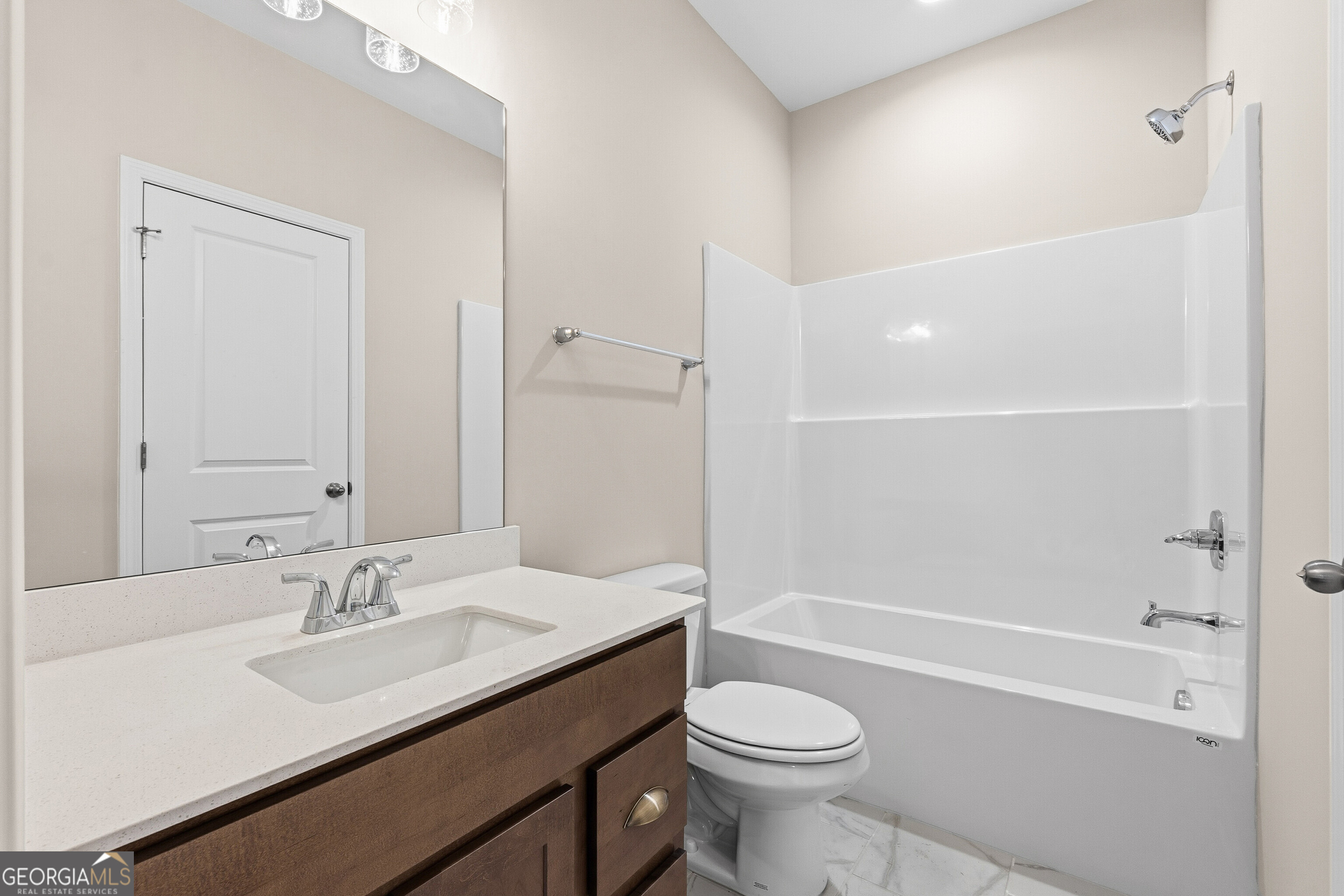 1649 Stokes Store Road, Unit 52 Forsyth, GA 31029 - Photo 38 of 73 a bathroom with a sink a toilet and shower