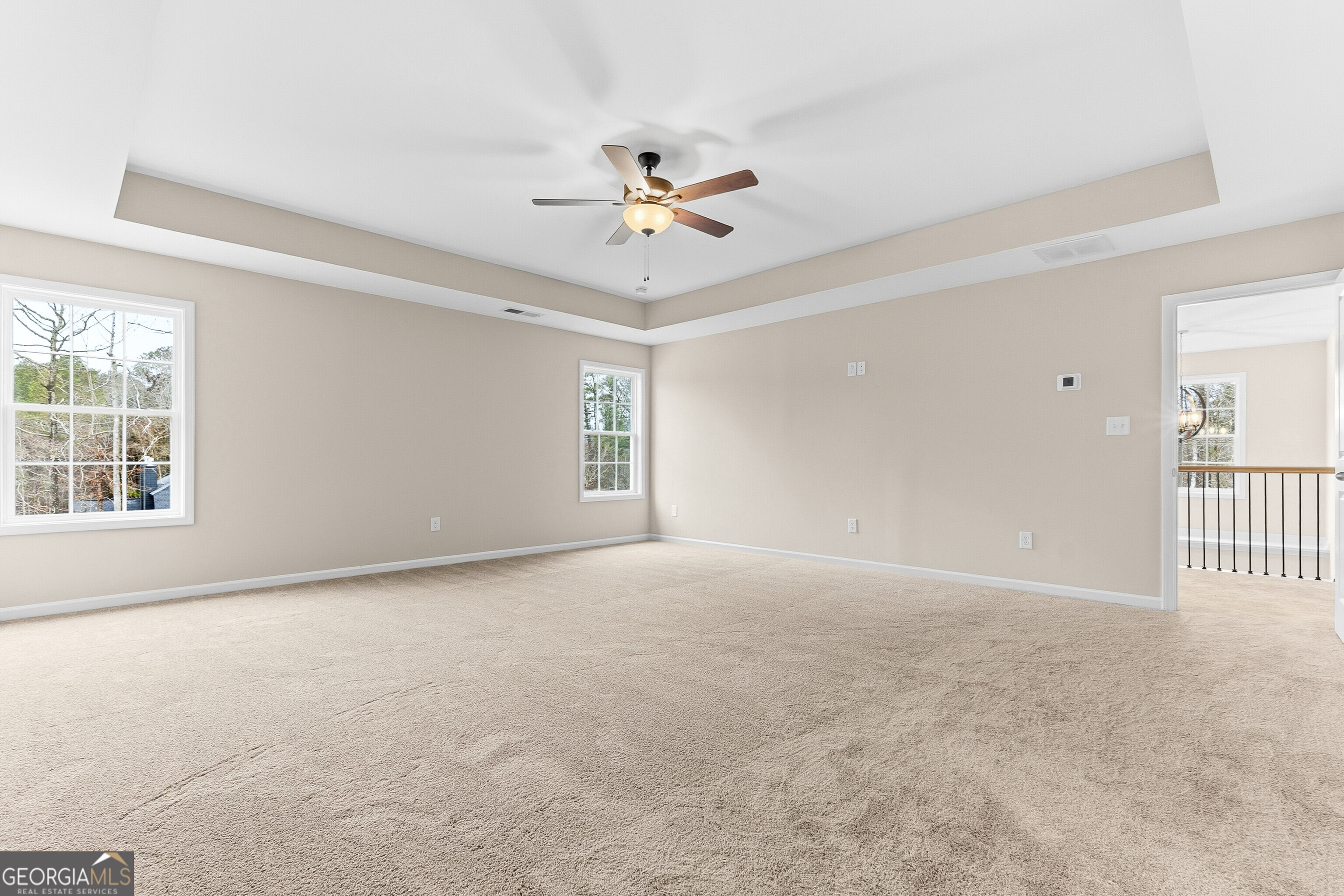 1649 Stokes Store Road, Unit 52 Forsyth, GA 31029 - Photo 41 of 73 an empty room with windows and fan chandelier fan