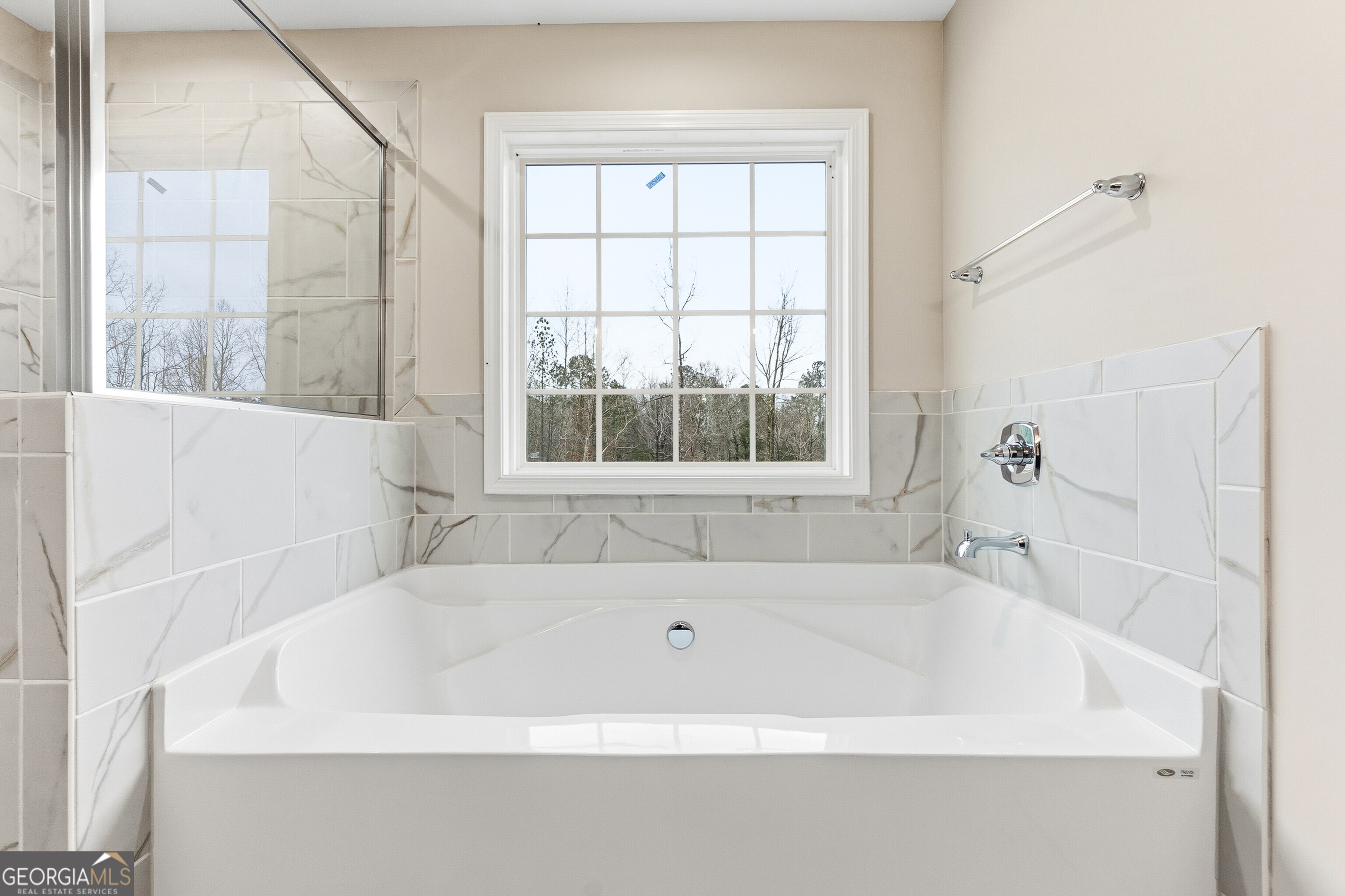 1649 Stokes Store Road, Unit 52 Forsyth, GA 31029 - Photo 47 of 73 a white bath tub sitting in a bathroom next to a window