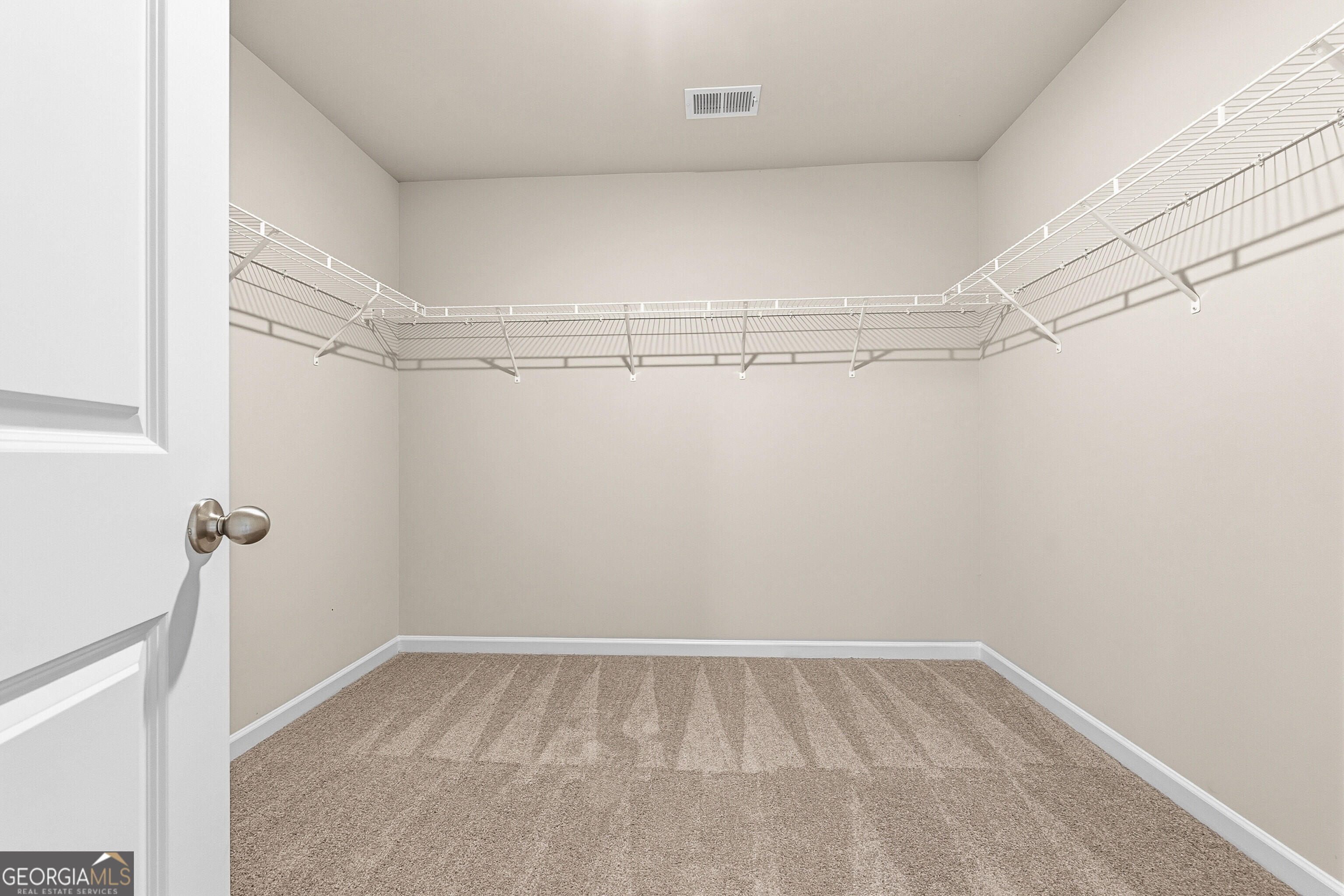 1649 Stokes Store Road, Unit 52 Forsyth, GA 31029 - Photo 58 of 73 a view of a room with racks on the wall