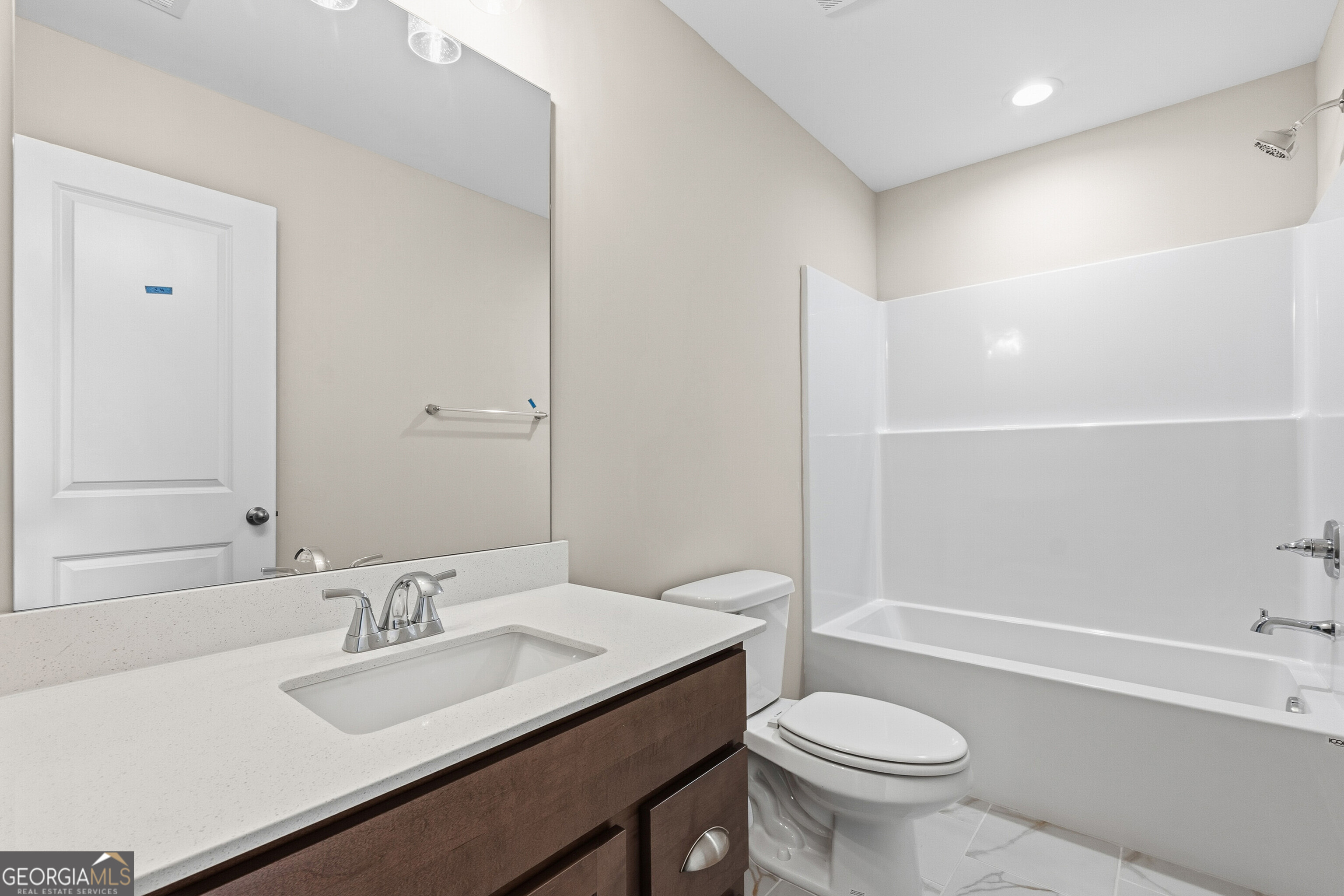 1649 Stokes Store Road, Unit 52 Forsyth, GA 31029 - Photo 59 of 73 a bathroom with a sink toilet vanity and shower