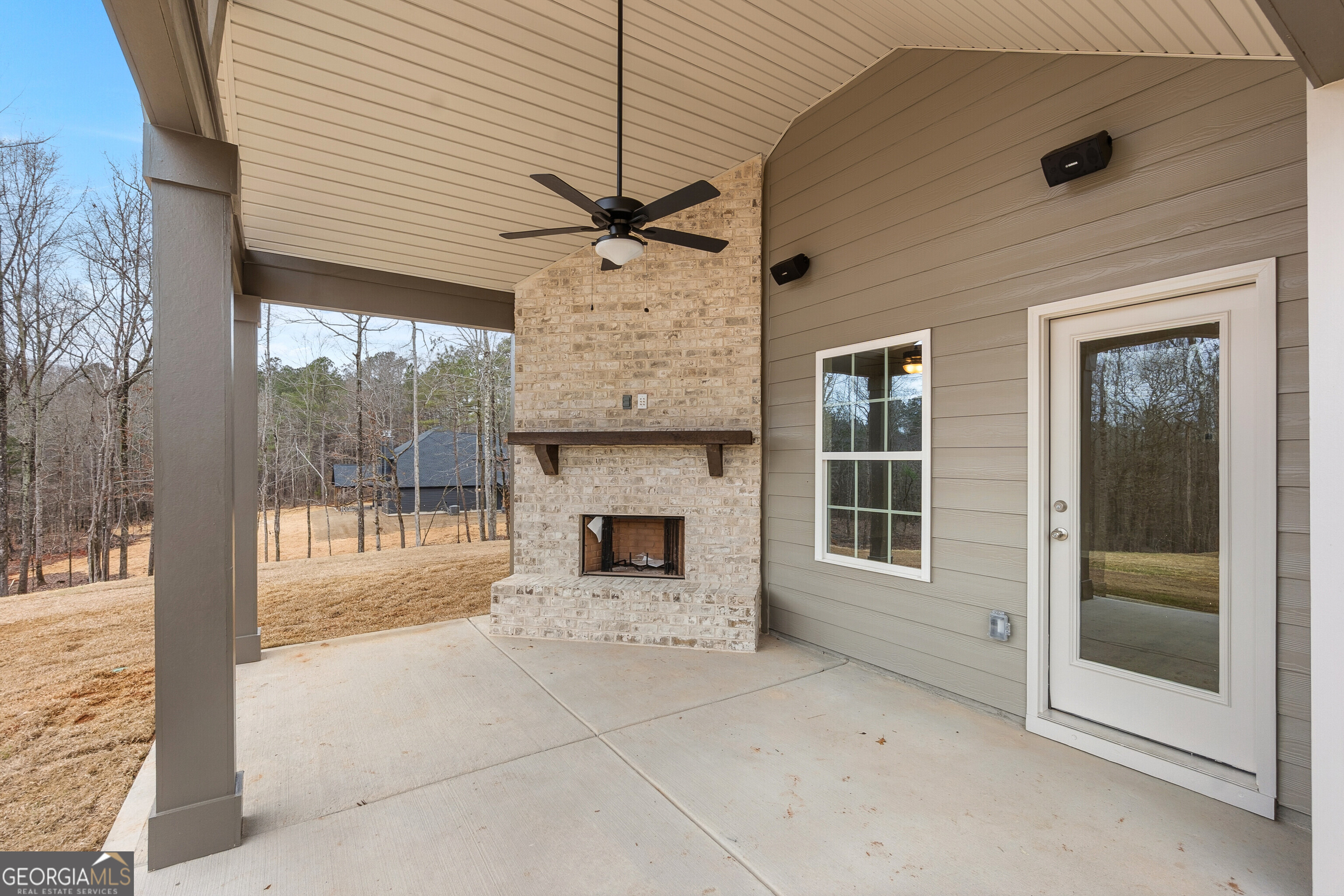 1649 Stokes Store Road, Unit 52 Forsyth, GA 31029 - Photo 62 of 73 a view of a porch with a table and chairs