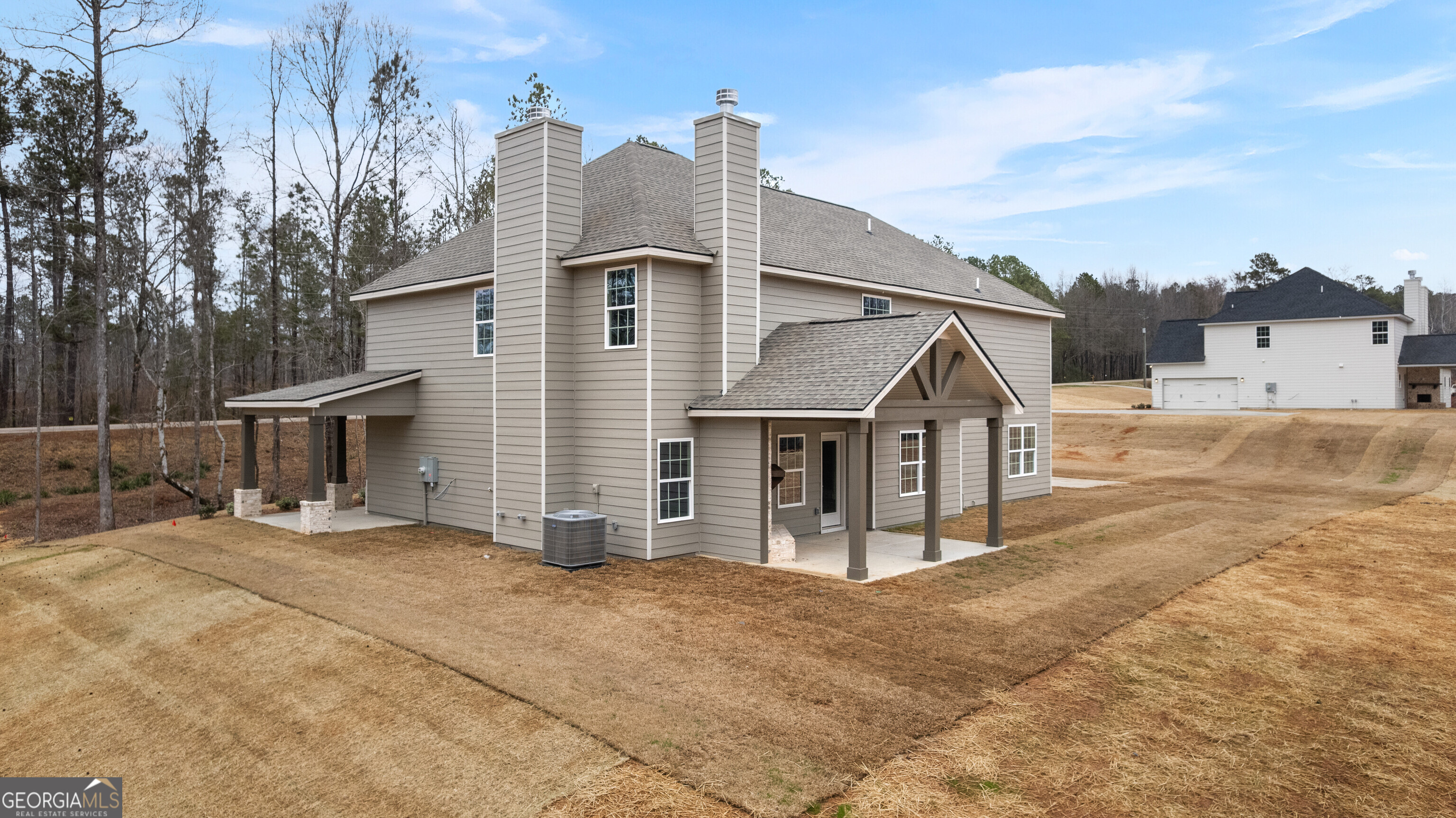 1649 Stokes Store Road, Unit 52 Forsyth, GA 31029 - Photo 66 of 73 a front view of a house with a yard and garage