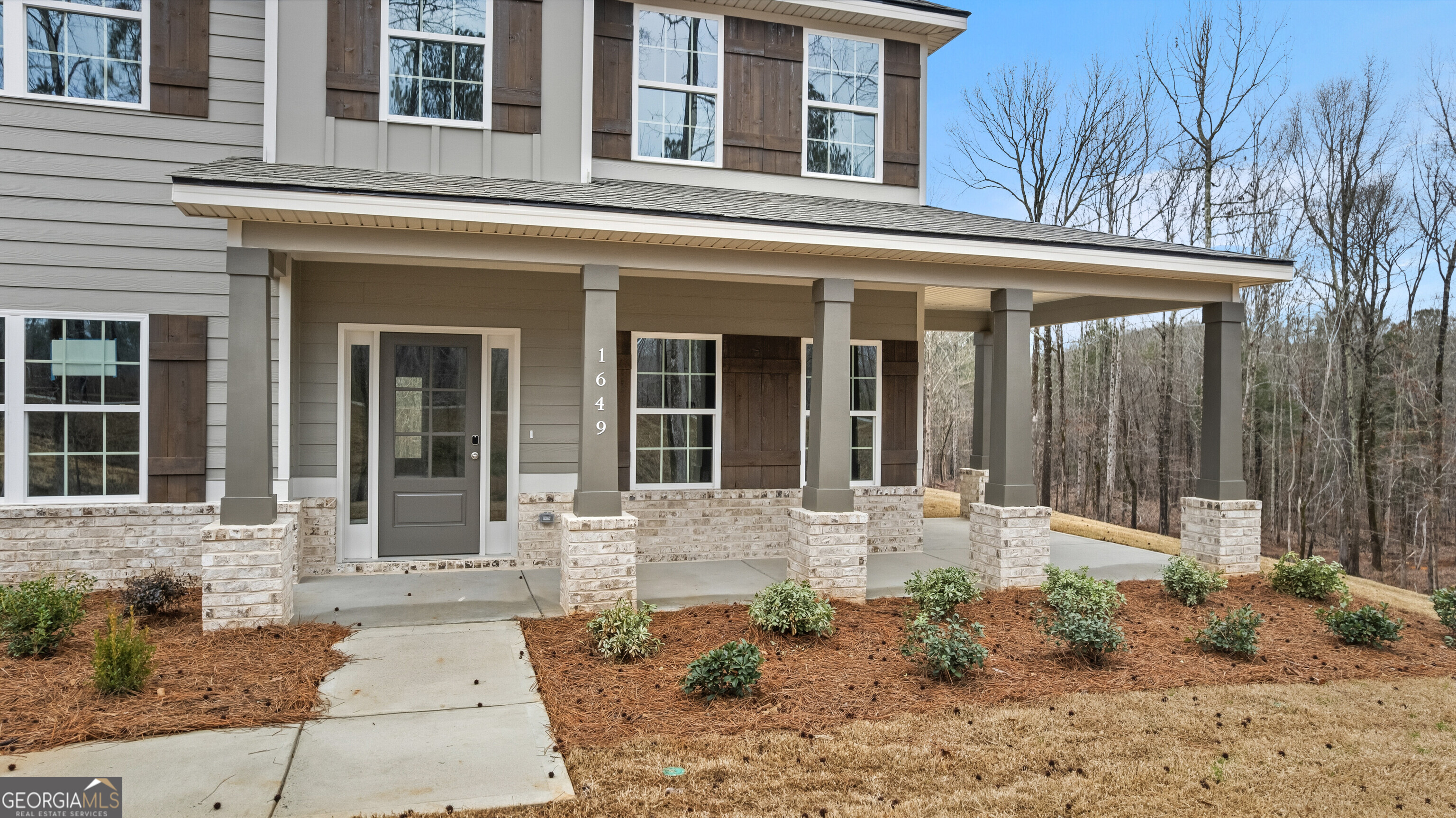 1649 Stokes Store Road, Unit 52 Forsyth, GA 31029 - Photo 8 of 73 front view of a brick house with a outdoor space