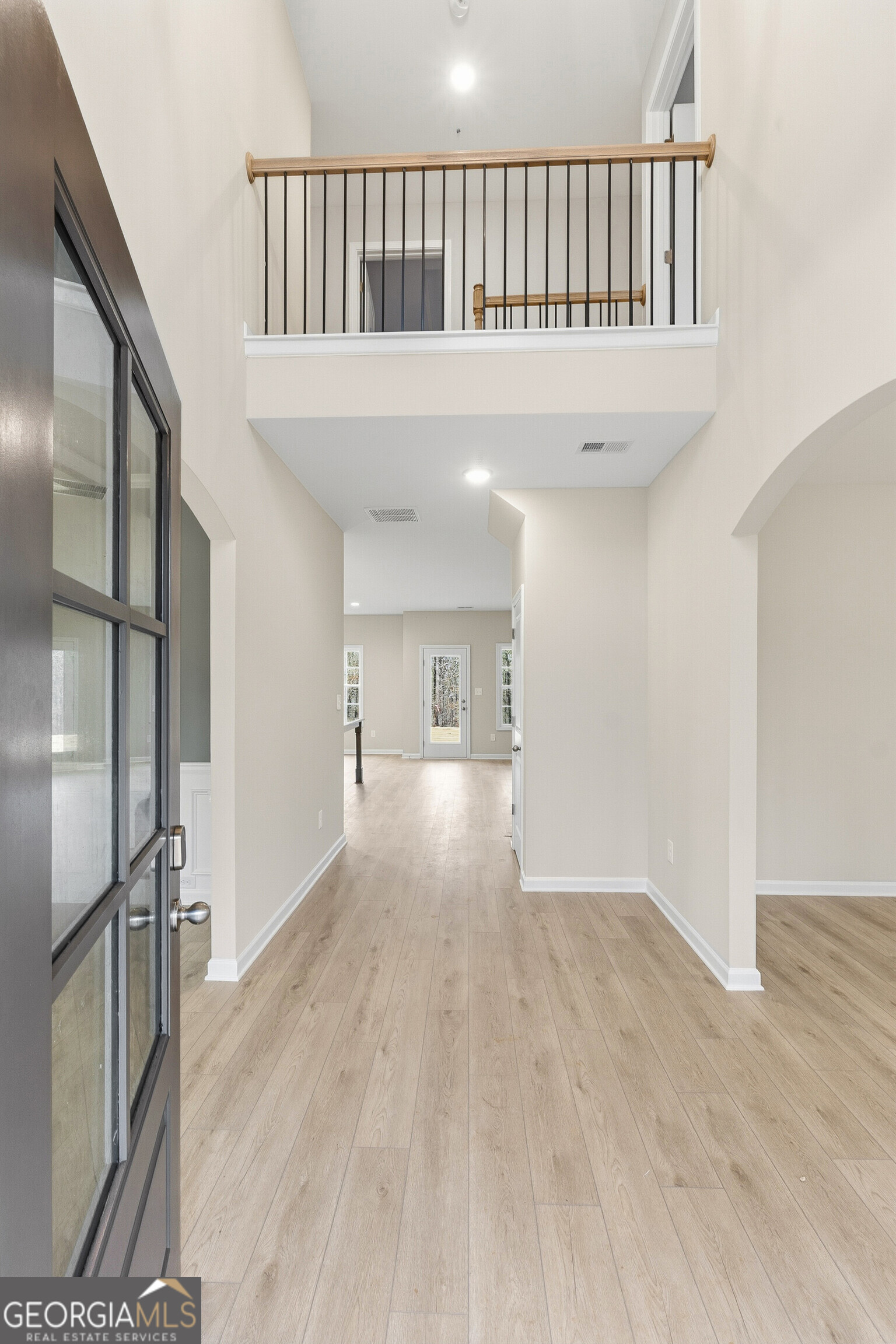 1649 Stokes Store Road, Unit 52 Forsyth, GA 31029 - Photo 9 of 73 a view of a hallway with wooden floor and entryway
