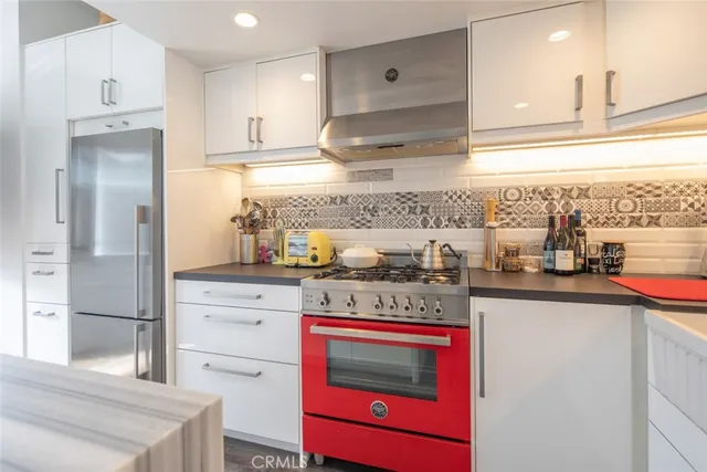 a kitchen with stainless steel appliances granite countertop a stove and a refrigerator